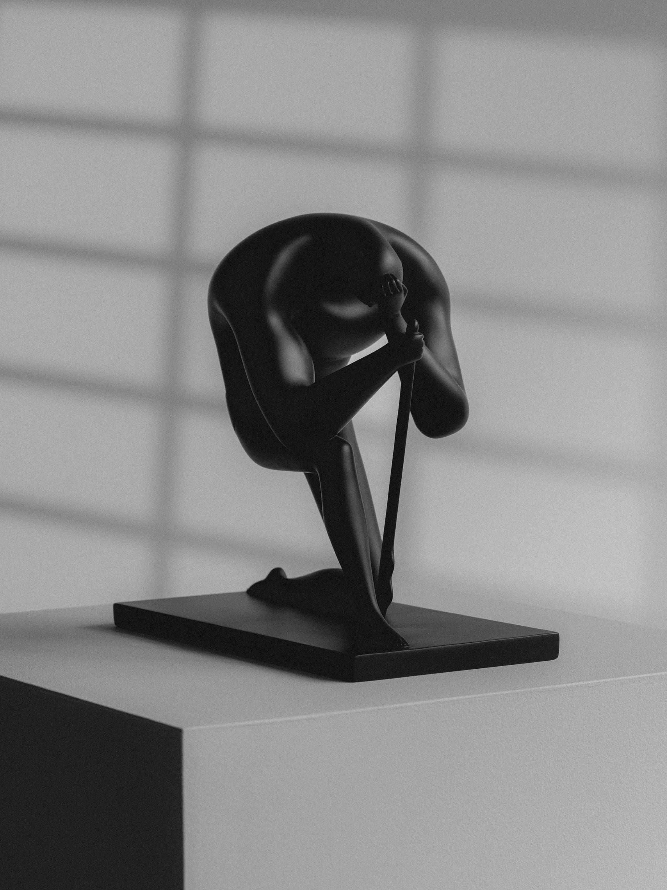 Cleon Peterson's 'Shame', photographed in black and white, and situated on a plinth