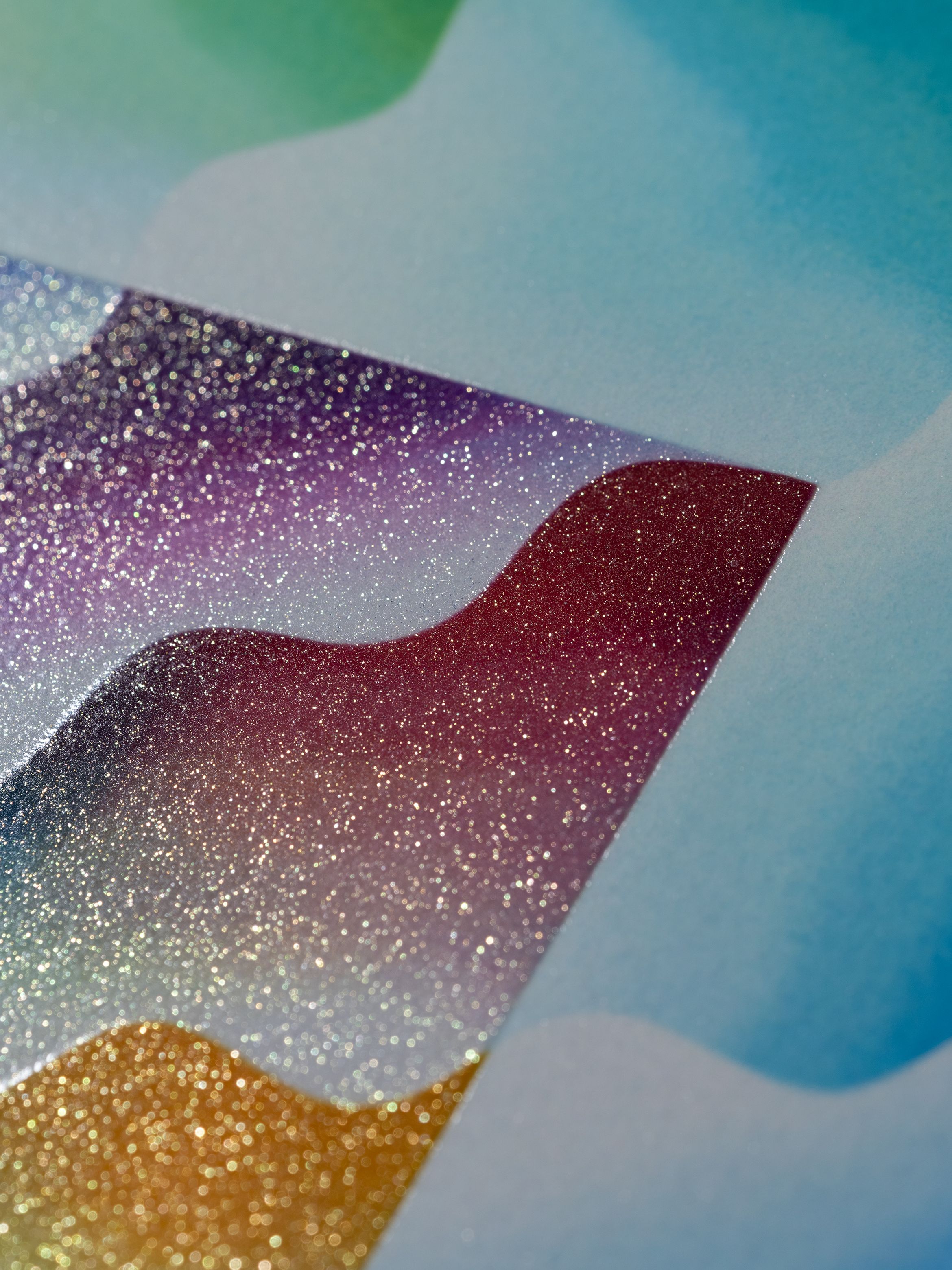 Abstract image with wavy, glittery gradients of blue, purple, red, and gold. The colours blend seamlessly, creating a shimmering effect.