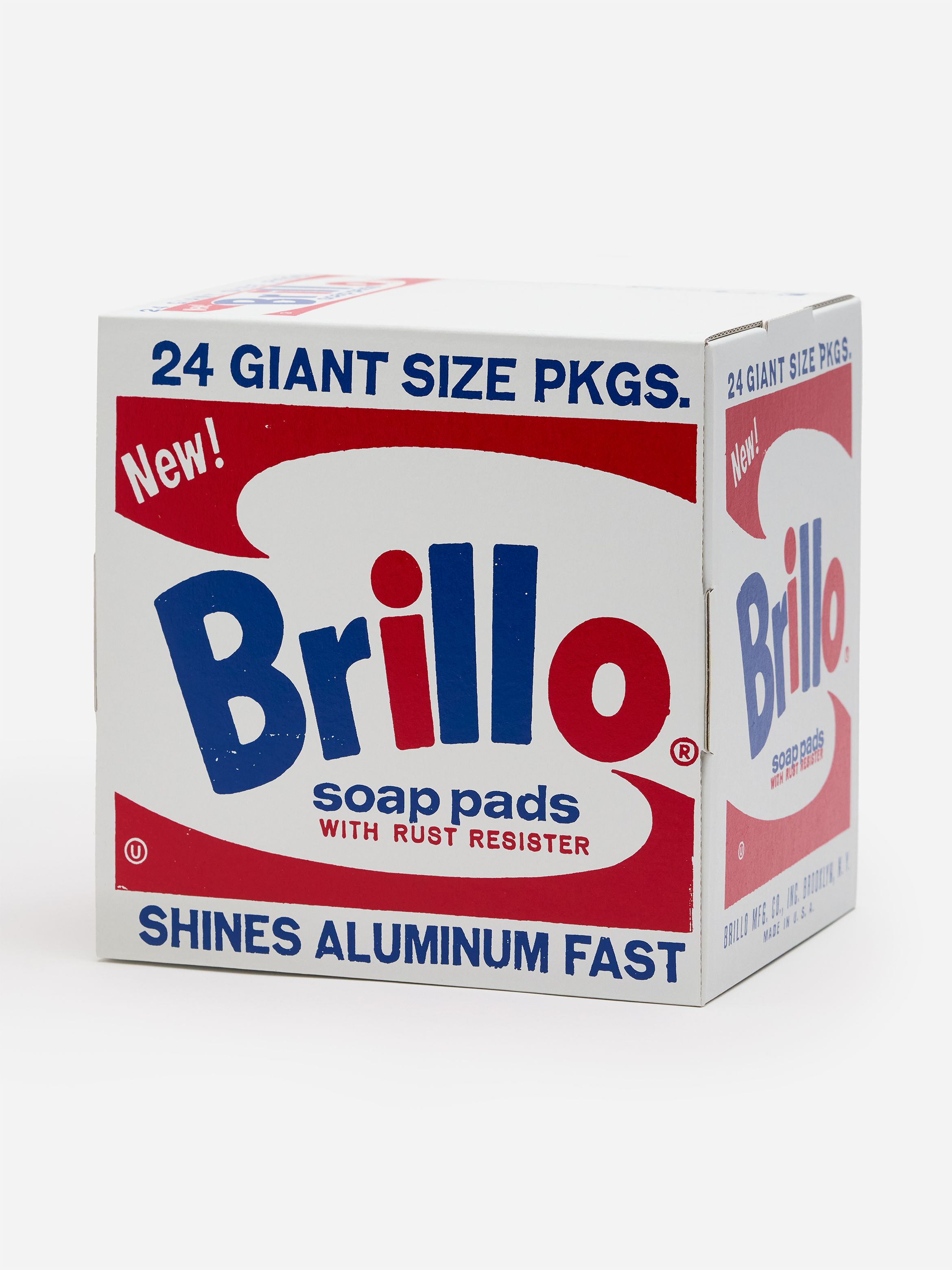 A box of Brillo soap pads with rust resister, featuring blue and red text, labeled "24 Giant Size PKGS" and "Shines Aluminum Fast."