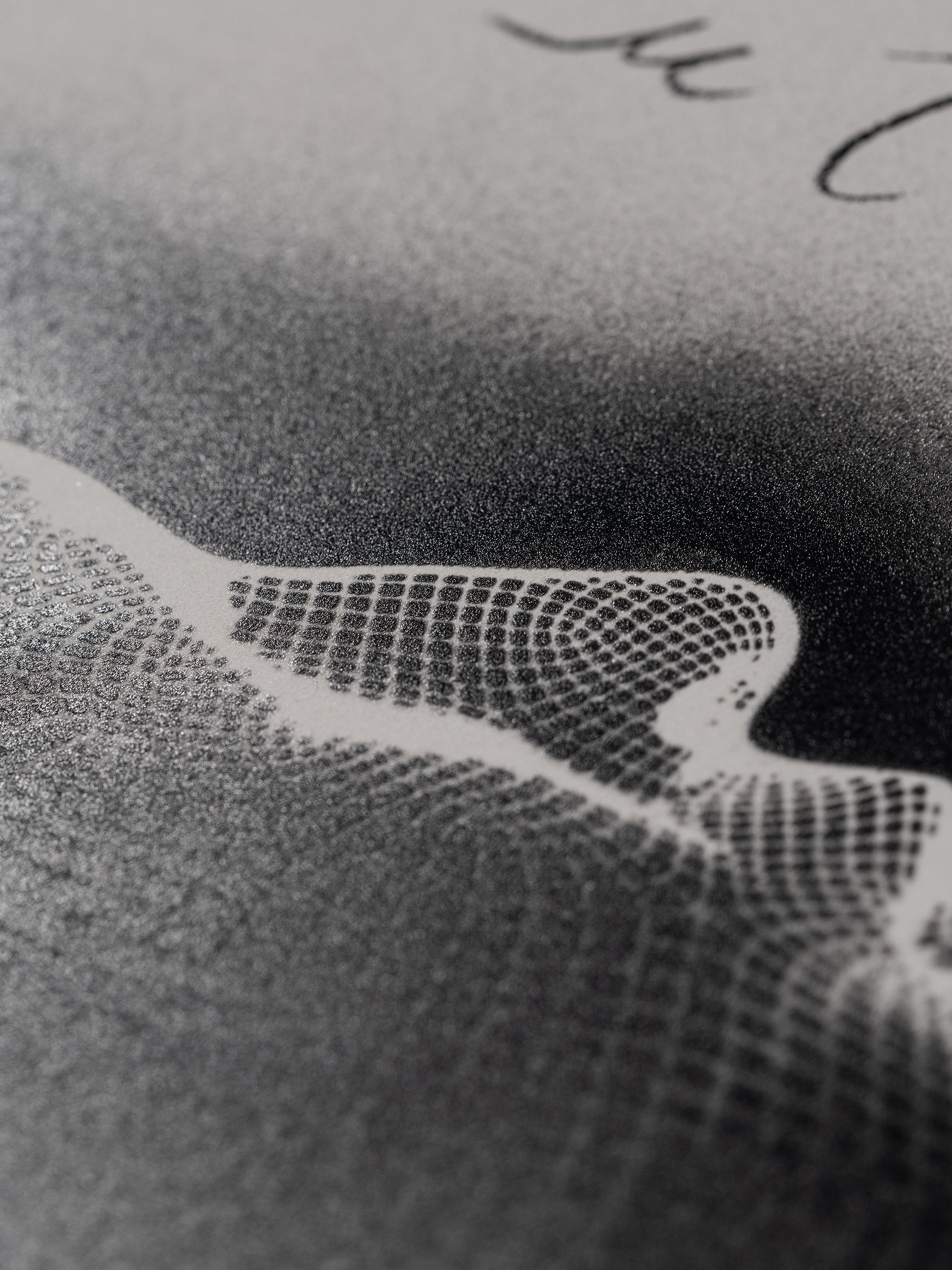 Close-up of a textured surface with a grid pattern transitioning from dark to light, overlaid with faint cursive writing.