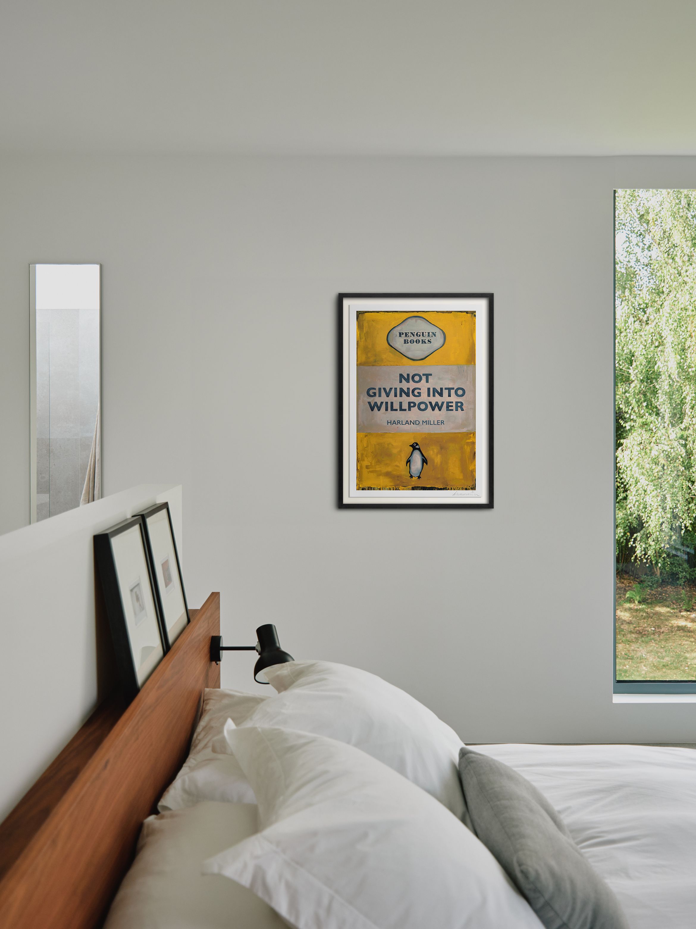 Hero of a silkscreen print in black frame on white wall by Harland Miller.