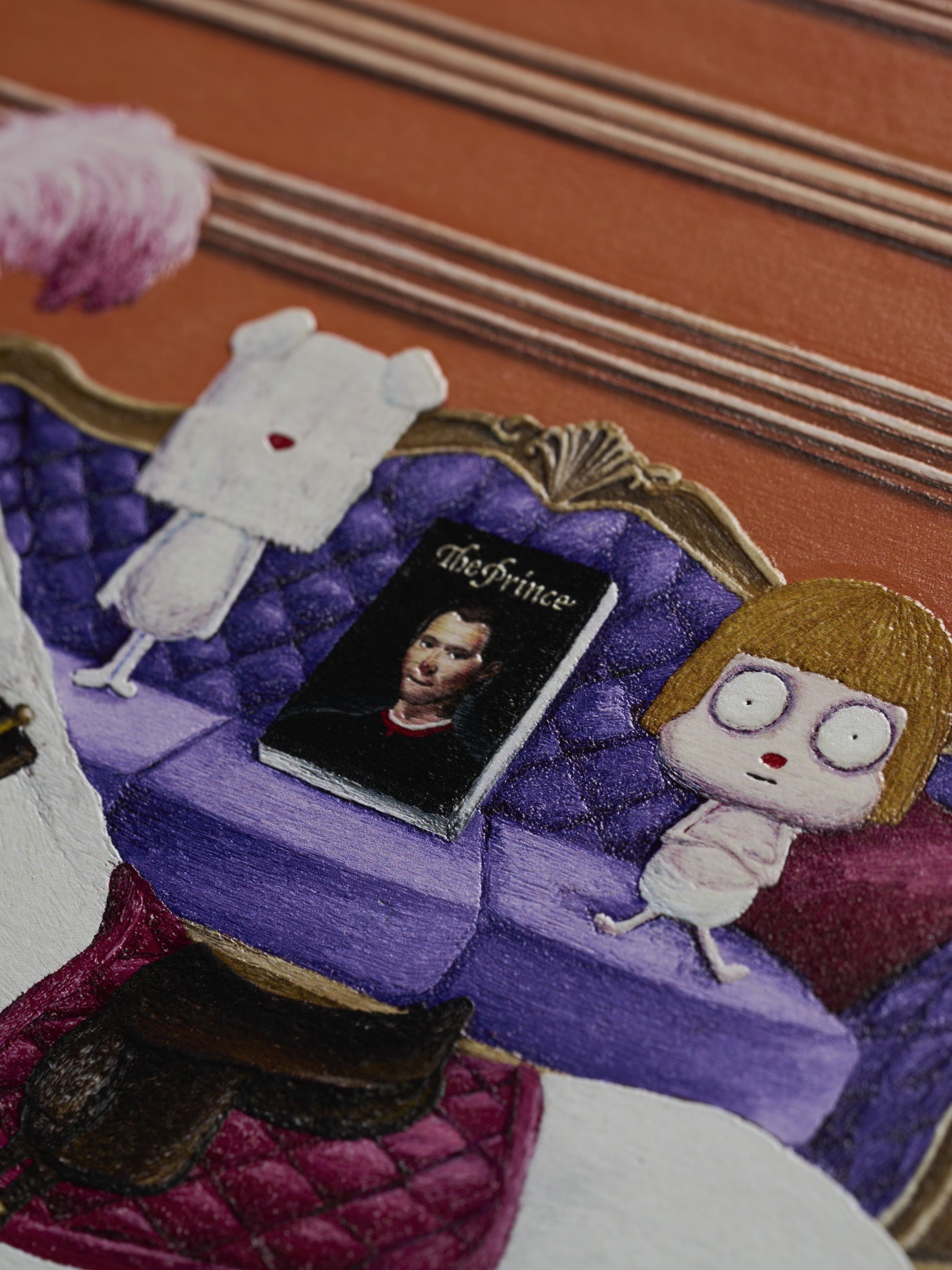 Whimsical illustration of a doll and a ghost-like figure on a purple sofa with "The Prince" book, set against an orange background.