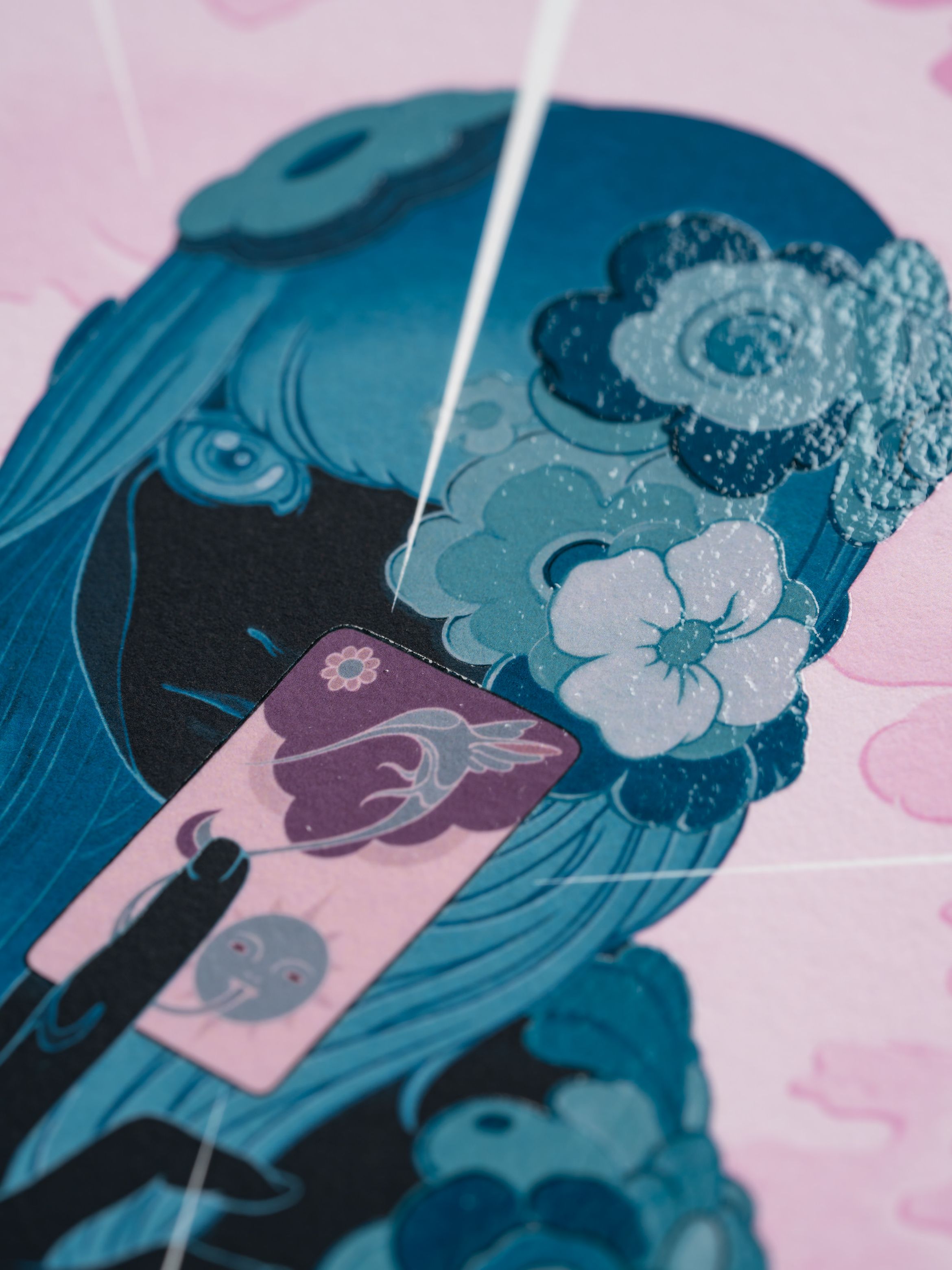 Illustration of a girl with blue flowers in her hair, holding a card with floral and moon designs against a pink background.