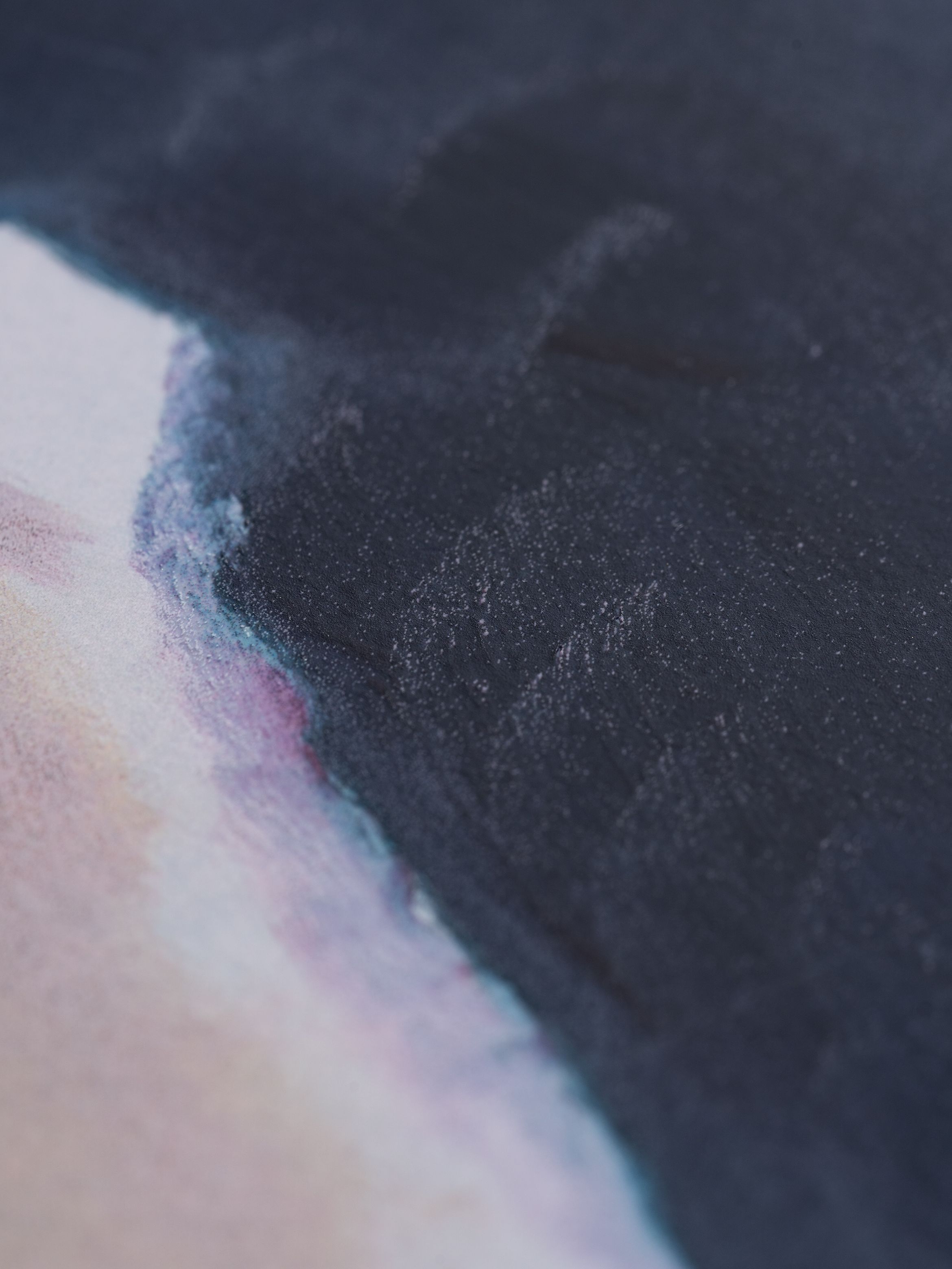 Close up of paint texture, dark blue blending into a washed pink