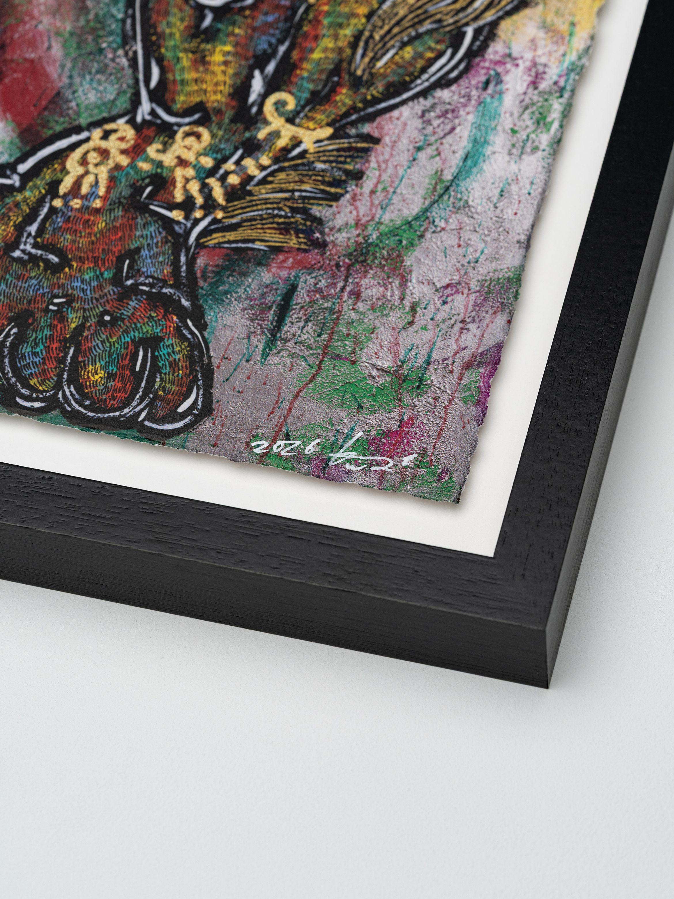 Close-up of a colourful abstract painting with textured brushstrokes, framed in black wood, featuring intricate gold details and a signature.
