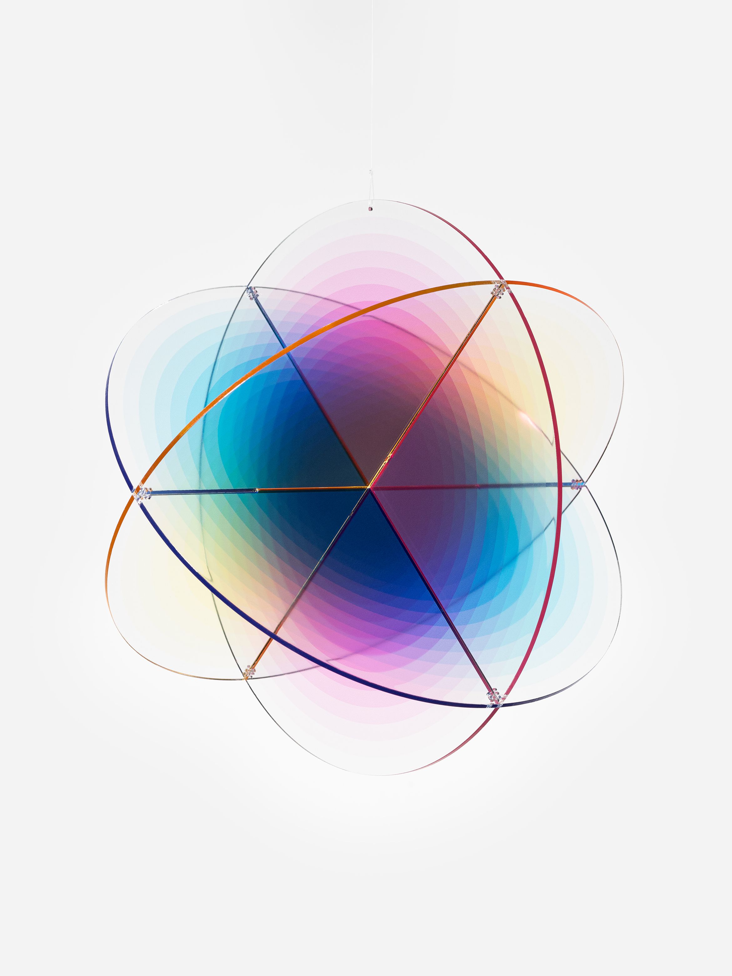 A spherical hanging sculpture with overlapping translucent panels in gradient hues of blue, pink, and yellow against a white background.