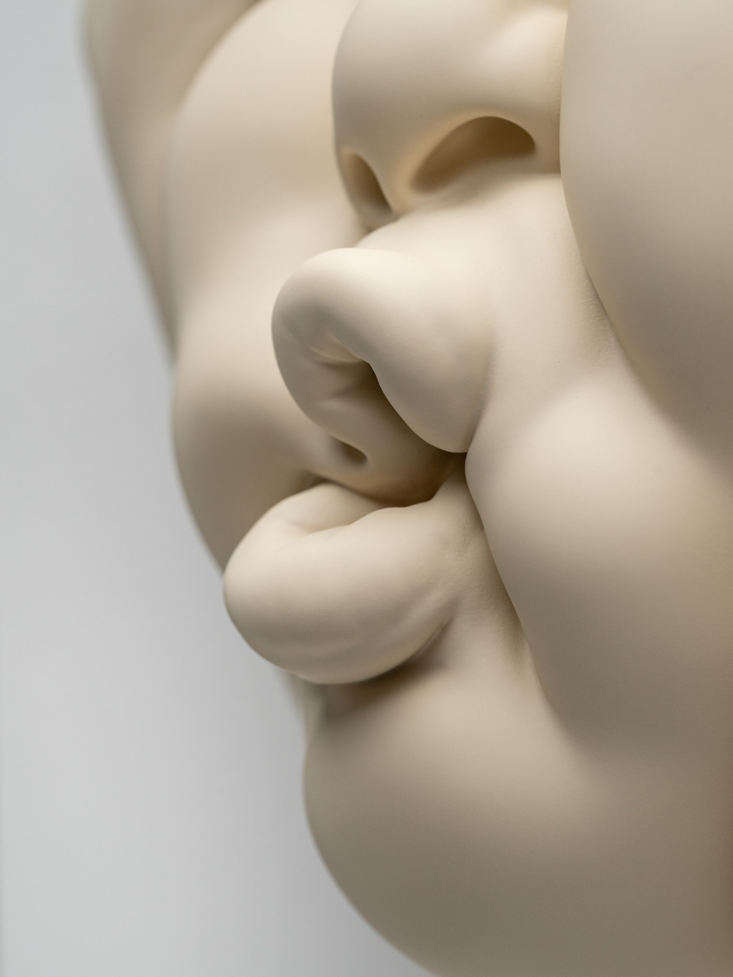 A close up detail of a new limited edition sculpture by Johnson Tsang that sees a face pursing their lips