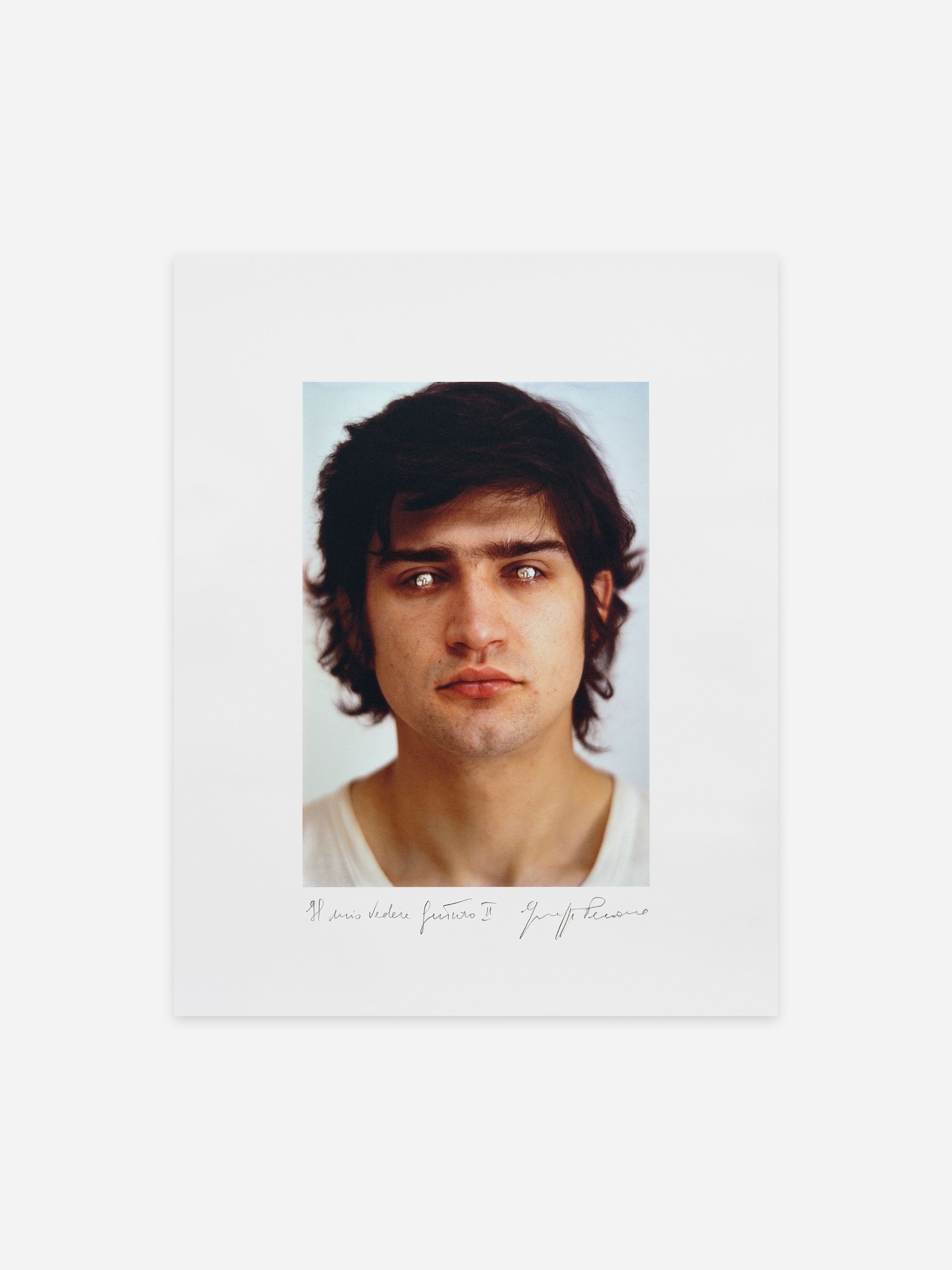 A portrait of a person with dark hair, eyes silver, and a neutral expression, set against a plain background. Handwritten text below the image. A portrait of a person with dark hair, eyes silver, and a neutral expression, set against a plain background. Handwritten text below the image.