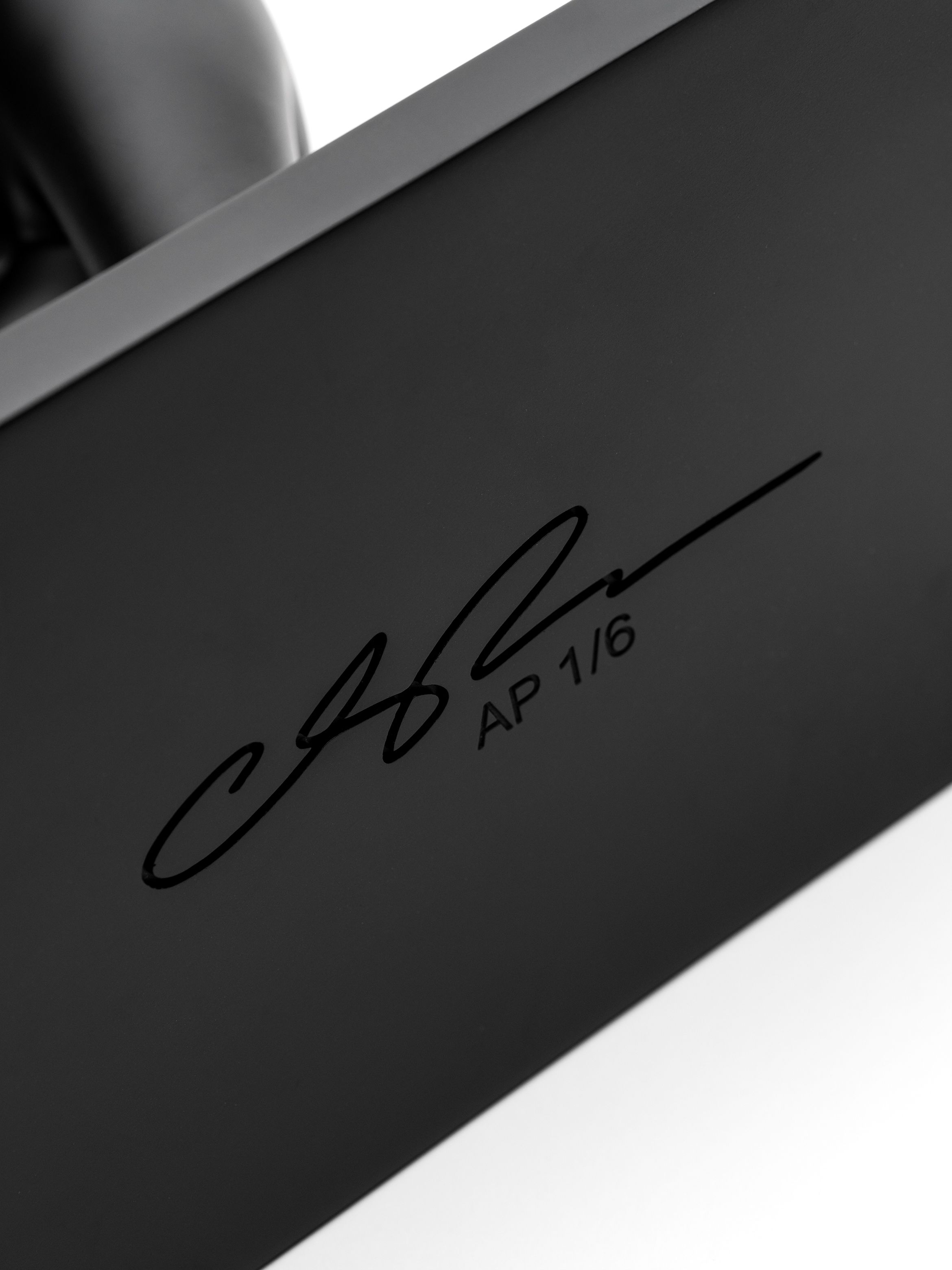 Signature detail of a resin cast sculpture by Cleon Peterson.