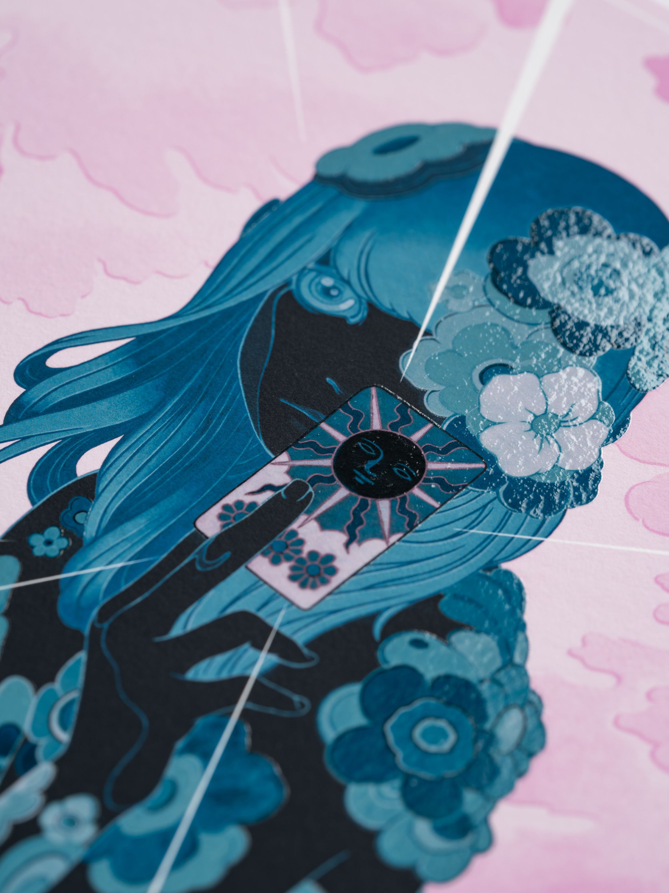 Illustration of a girl with blue hair, holding a tarot card. Surrounded by flowers, set against a pink background with clouds.