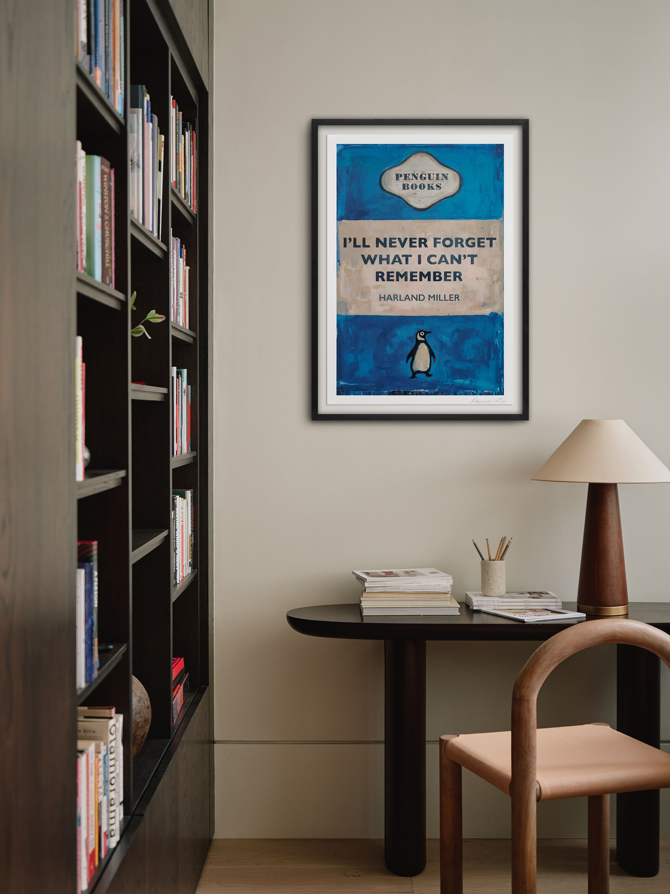 Hero of a silkscreen print in black frame on white wall by Harland Miller.