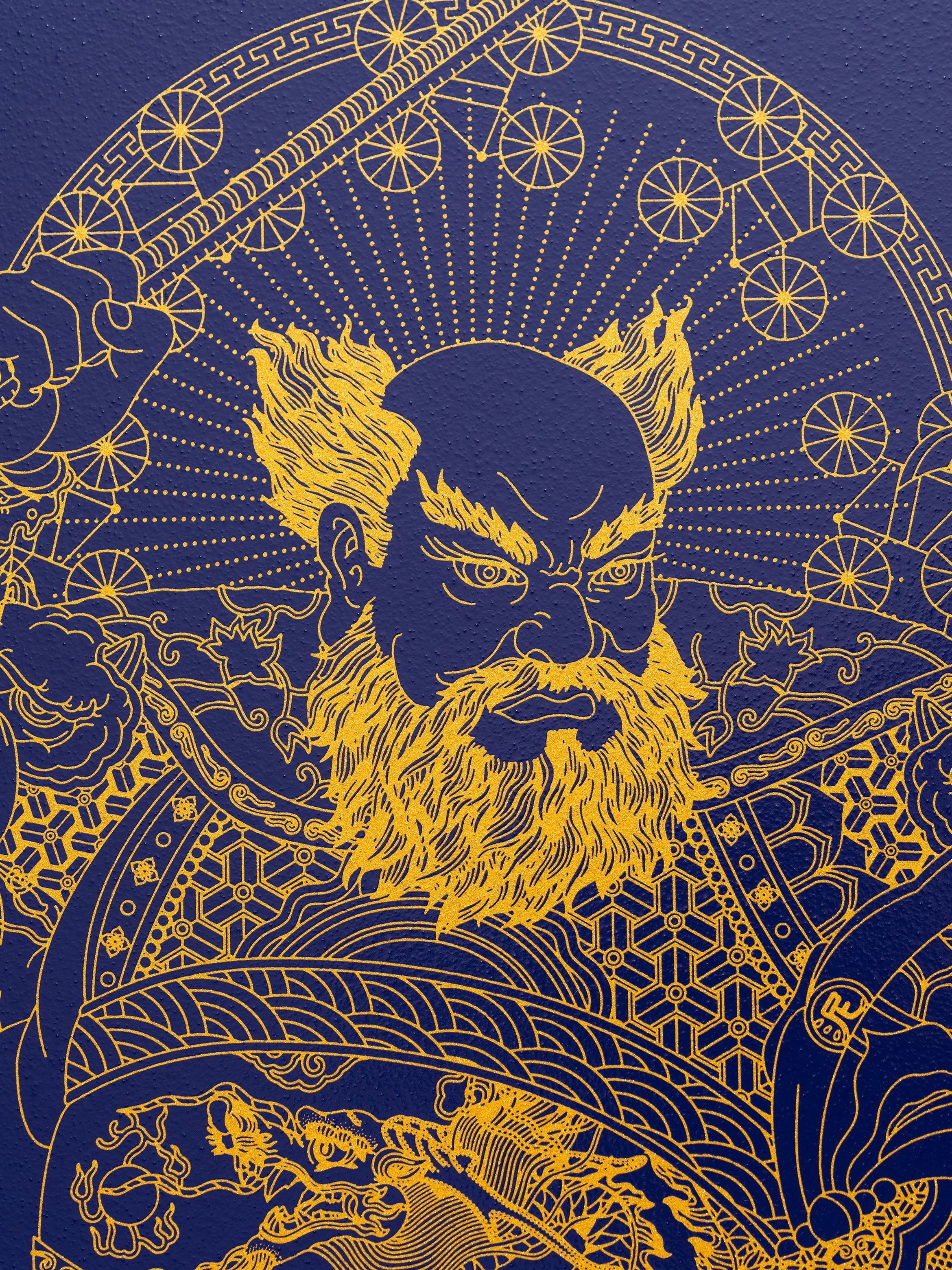 Intricate gold line art of a fierce, bearded warrior holding a staff on a deep blue background, surrounded by geometric patterns.