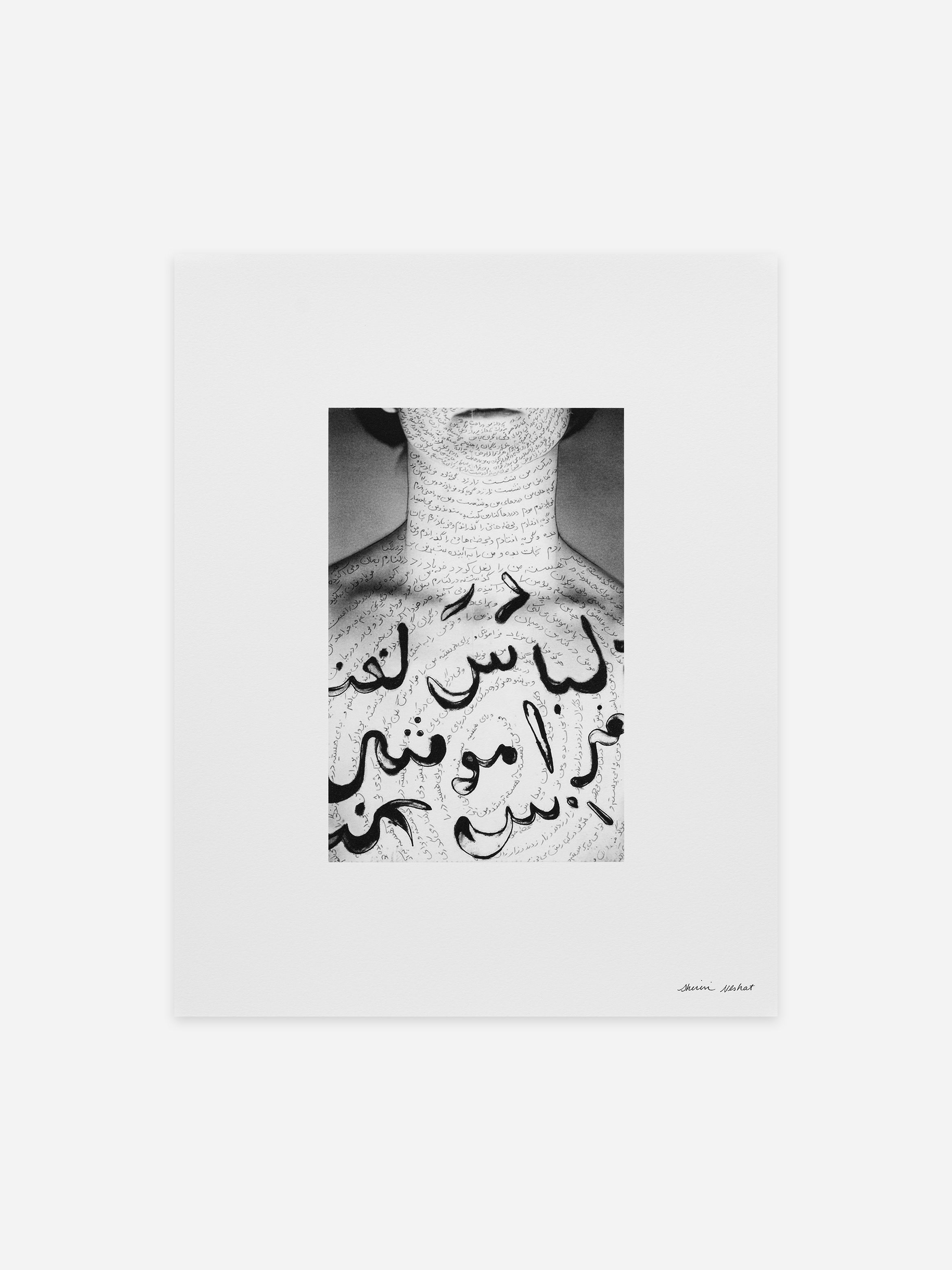 Black and white photo of a person with Arabic script artistically written on their chest and neck, surrounded by a white border.