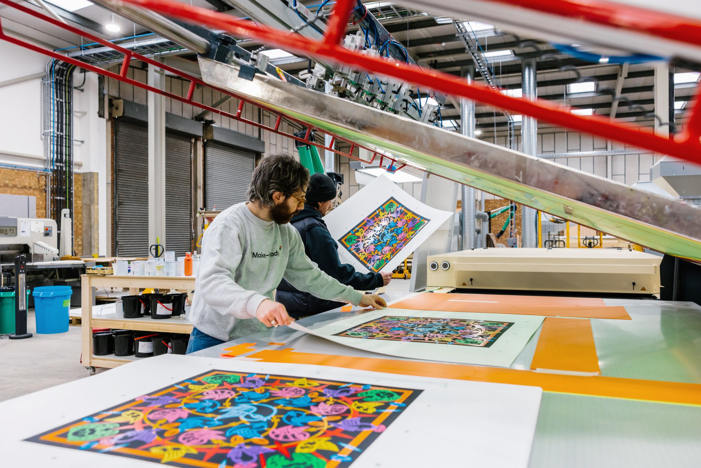 printmakers moving prints along the production line