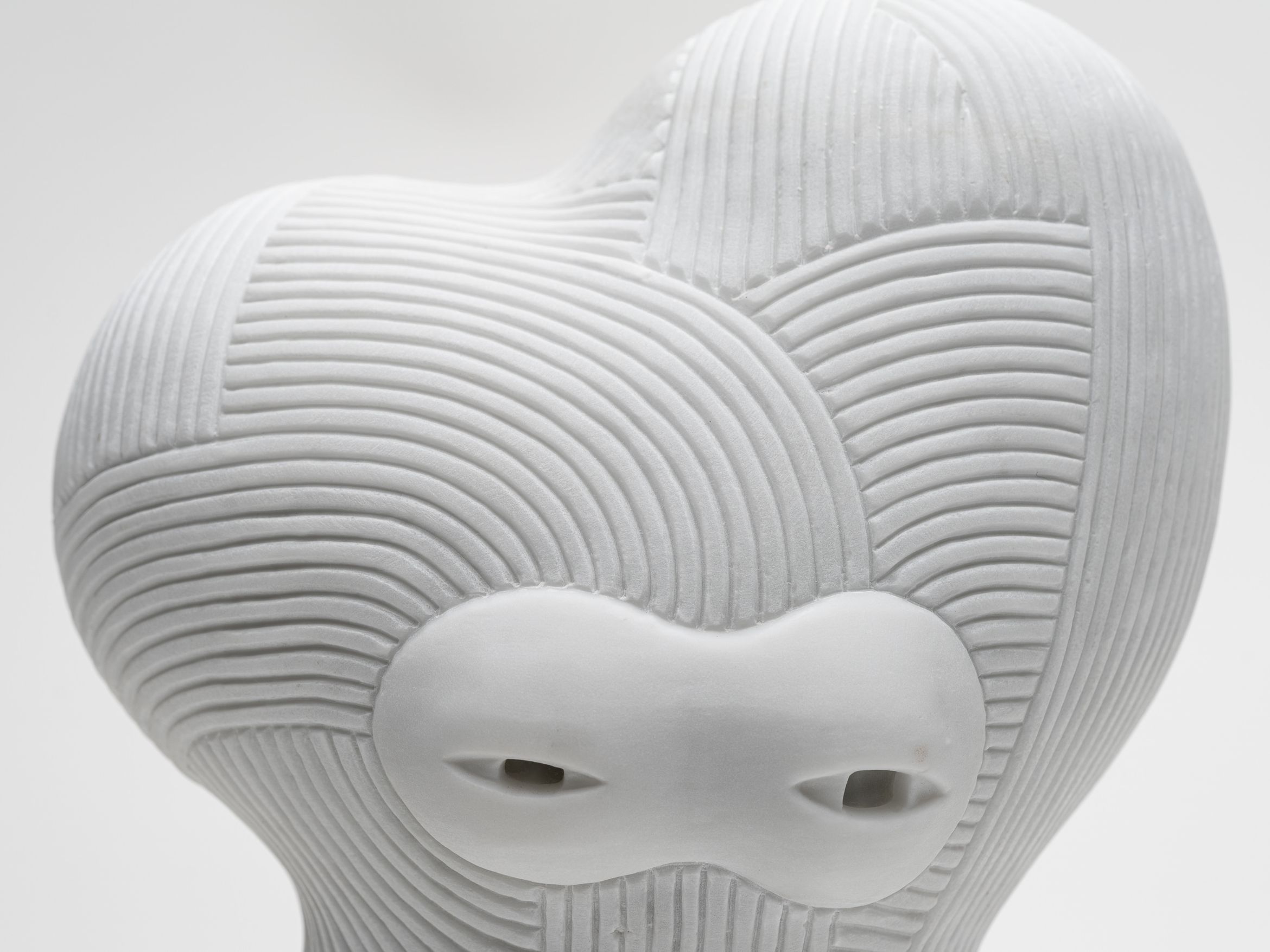 Straight-on detail of a marble sculpture by En Iwamura.