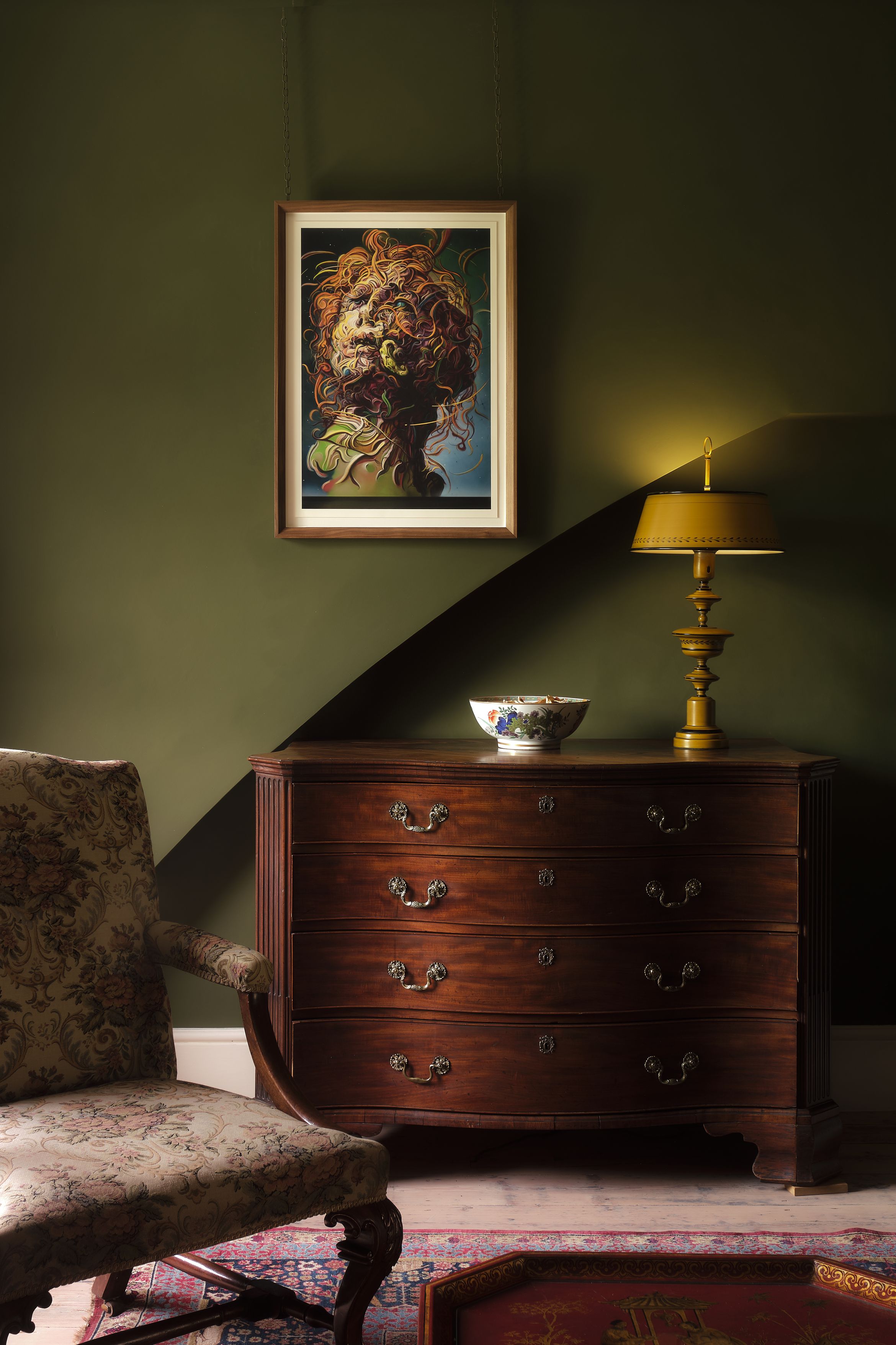 An achival pigment print by Glenn Brown framed in the artist's home, on a sage green wall.