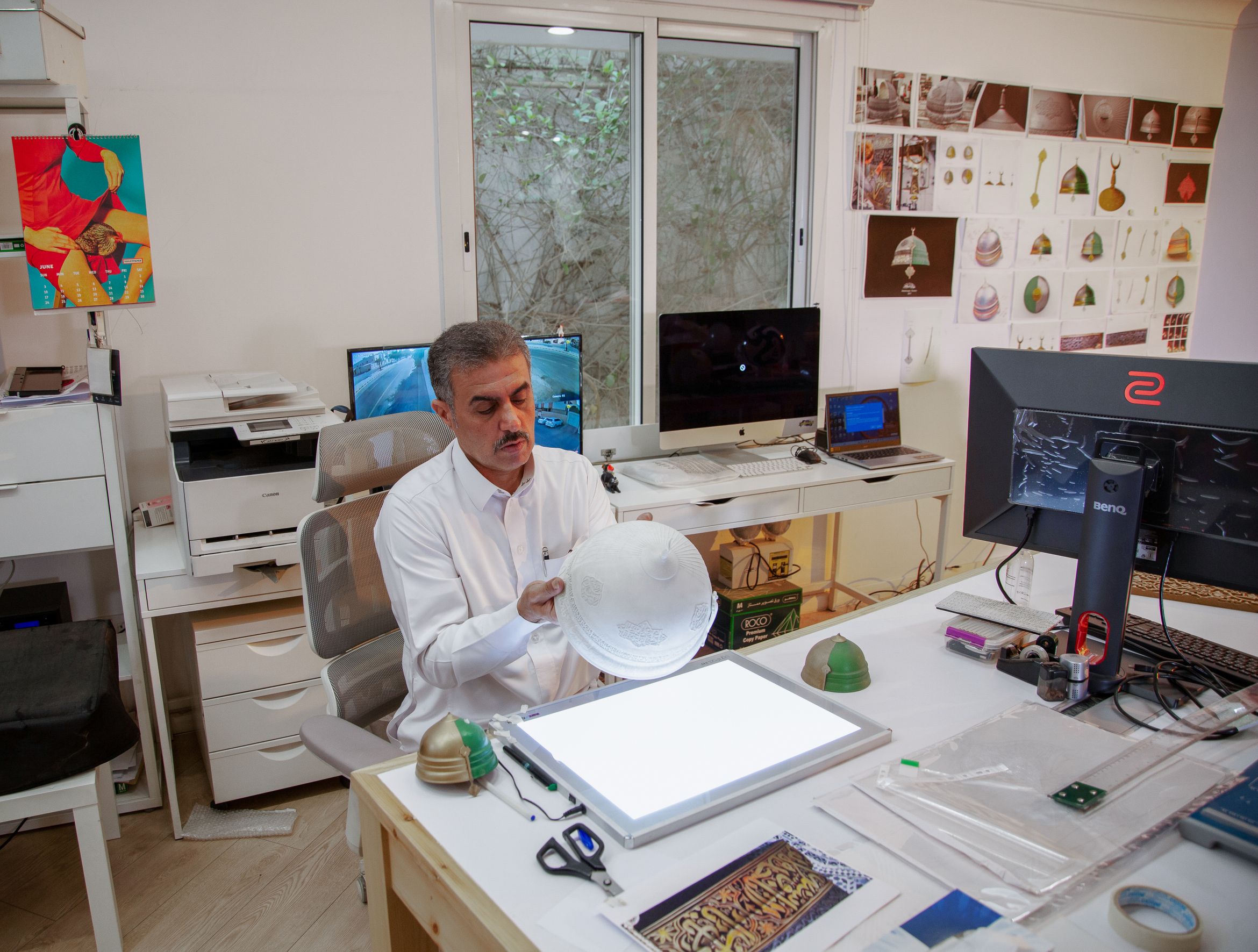 Artist Abdulnasser Gharem inspects a sculpture in his studio.