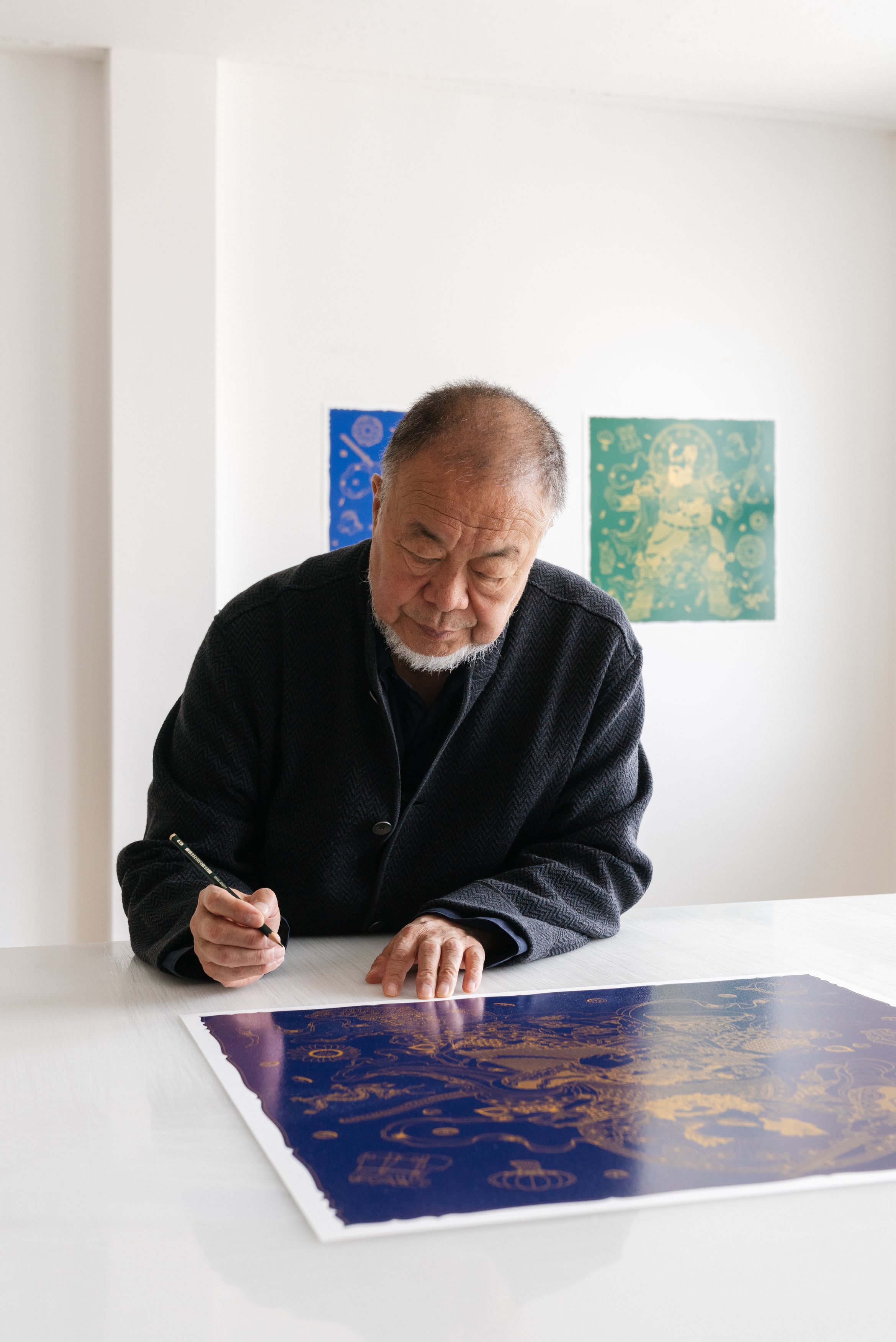 Ai Weiwei signing his latest limited edition silkscreen print