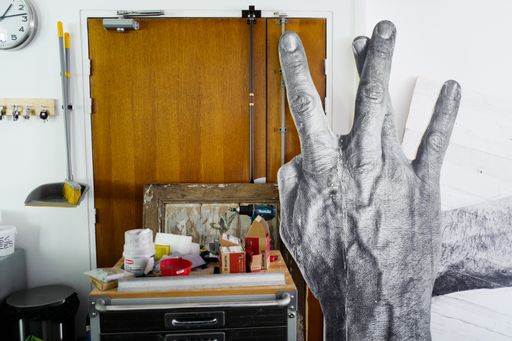 JR's artwork of a large hand, in his studio JR's artwork of a large hand, in his studio