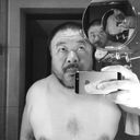 artist Ai Weiwei taking a selfie in a bathroom mirror