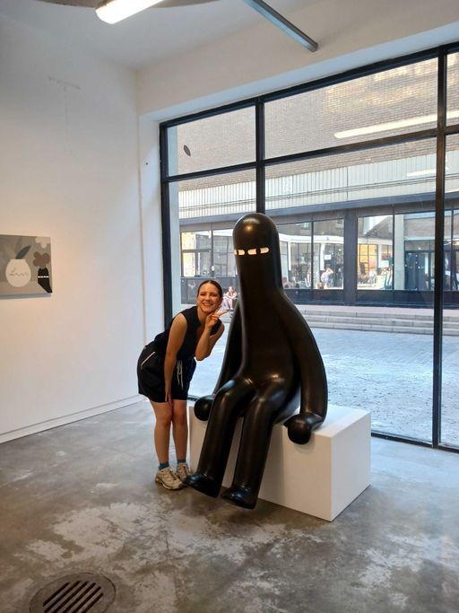 Someone standing next to a LY sculpture in London Someone standing next to a LY sculpture in London
