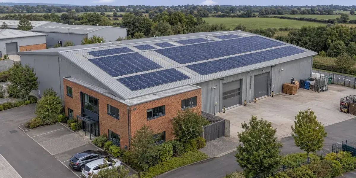 Illustrative aerial view of solar panels on a commercial building roof