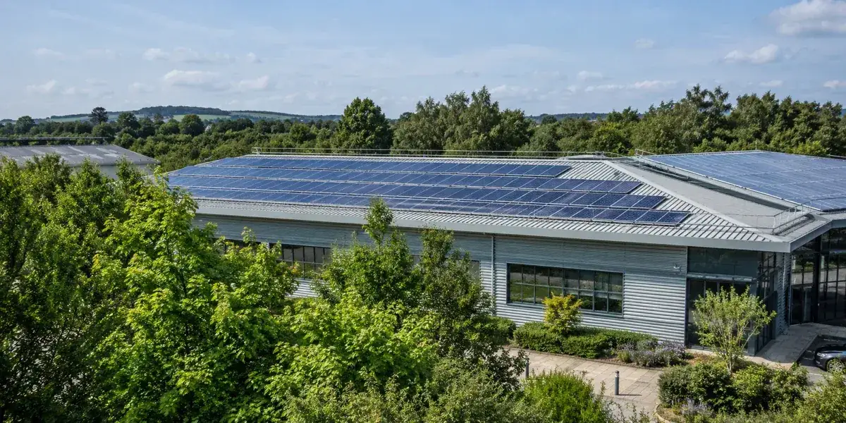 Illustrative commercial solar installation surrounded by green landscaping