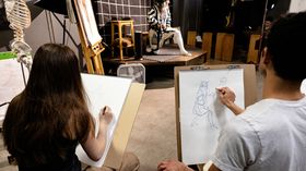 Students drawing in Costumed Figure Drawing class