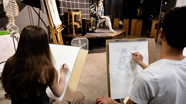 Students drawing in Costumed Figure Drawing class