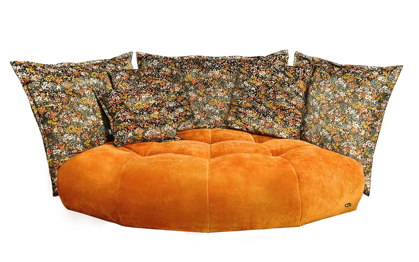 Orange plush sofa with tufted design, paired with large, colorful floral-patterned pillows.