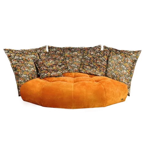 Orange plush sofa with tufted design, paired with large, colorful floral-patterned pillows.