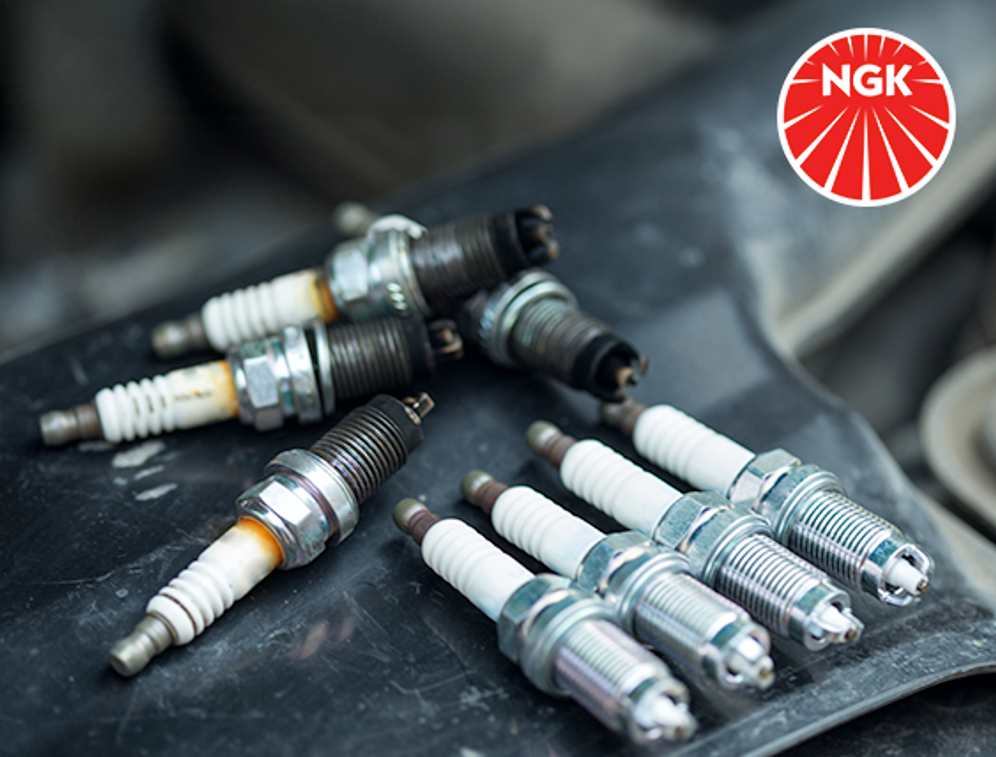 Bougies d'allumage NGK sur le capot d'un vehicule avec logo NGK