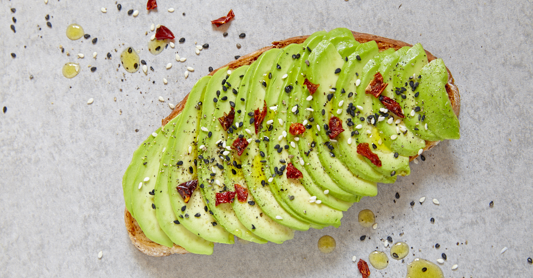 Avocado toast with sesame seeds and red pepper flakes, to indicate this post is about Millennials