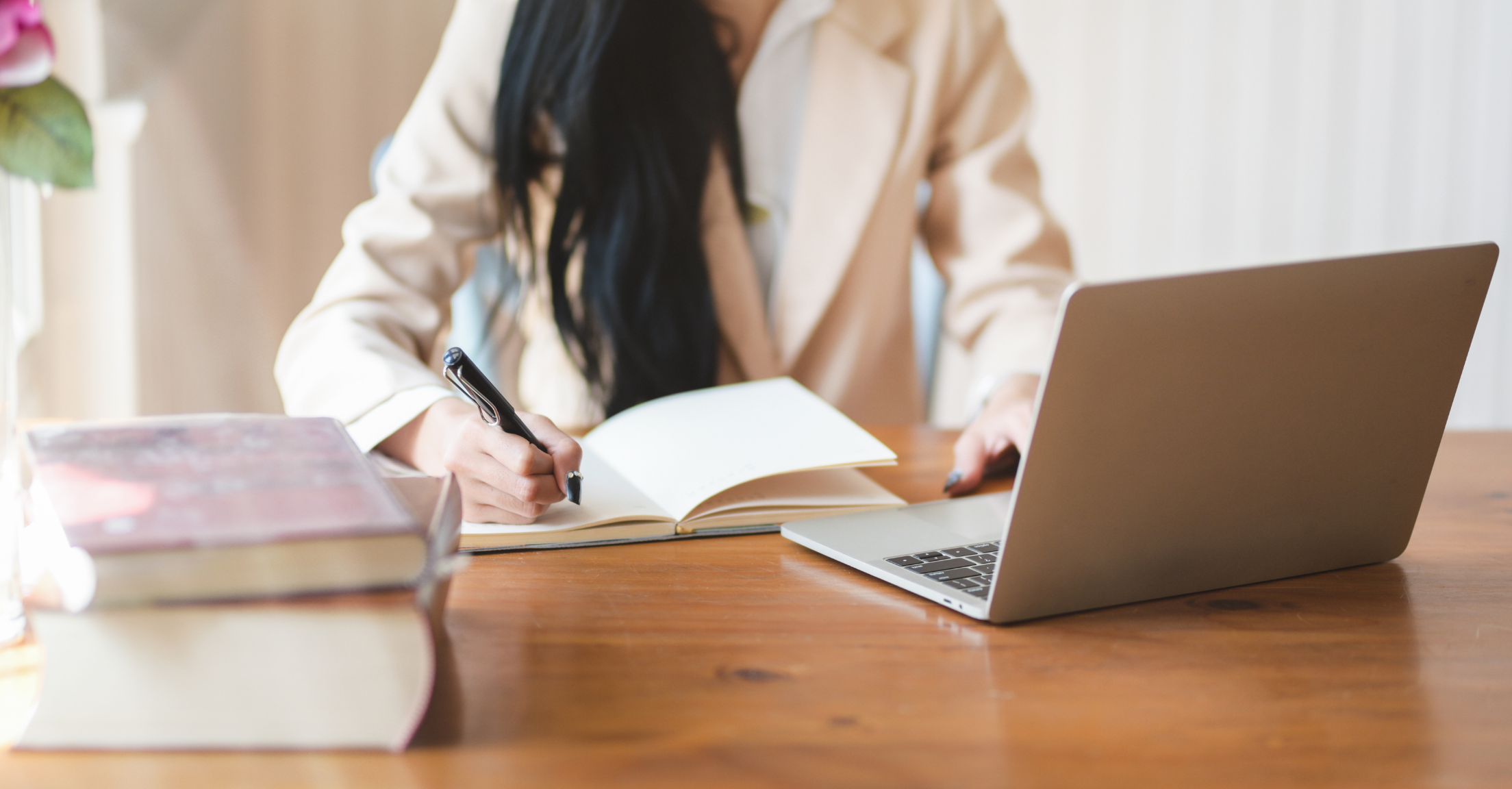 Woman taking notes while watching a RightCapital webinar on her laptop