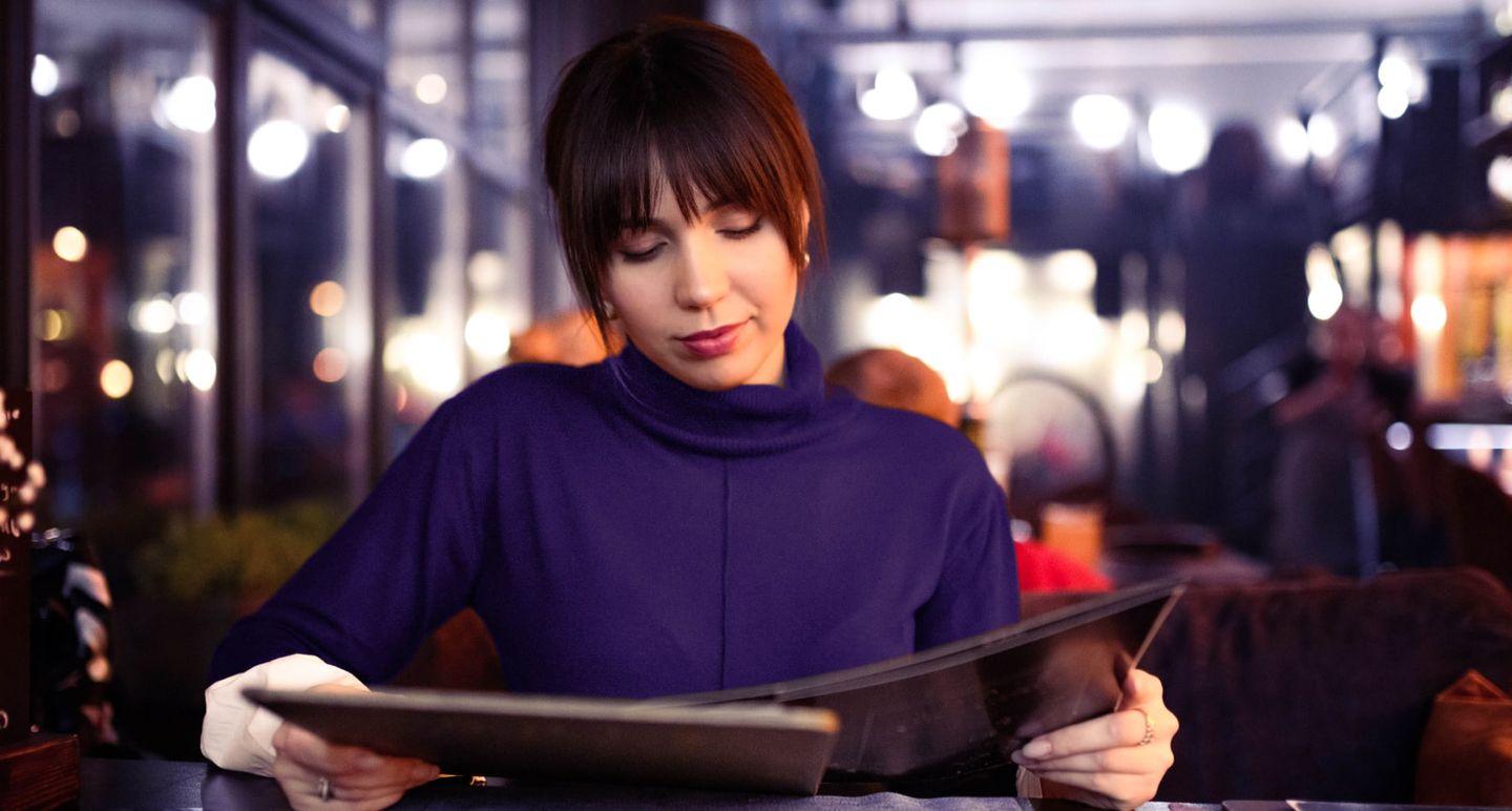 Woman holding a menu