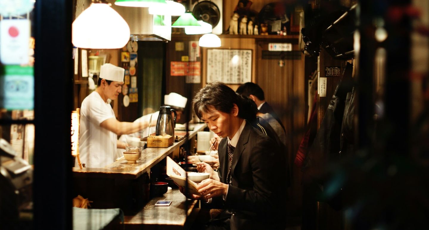 Man eats in a counter table in Japan