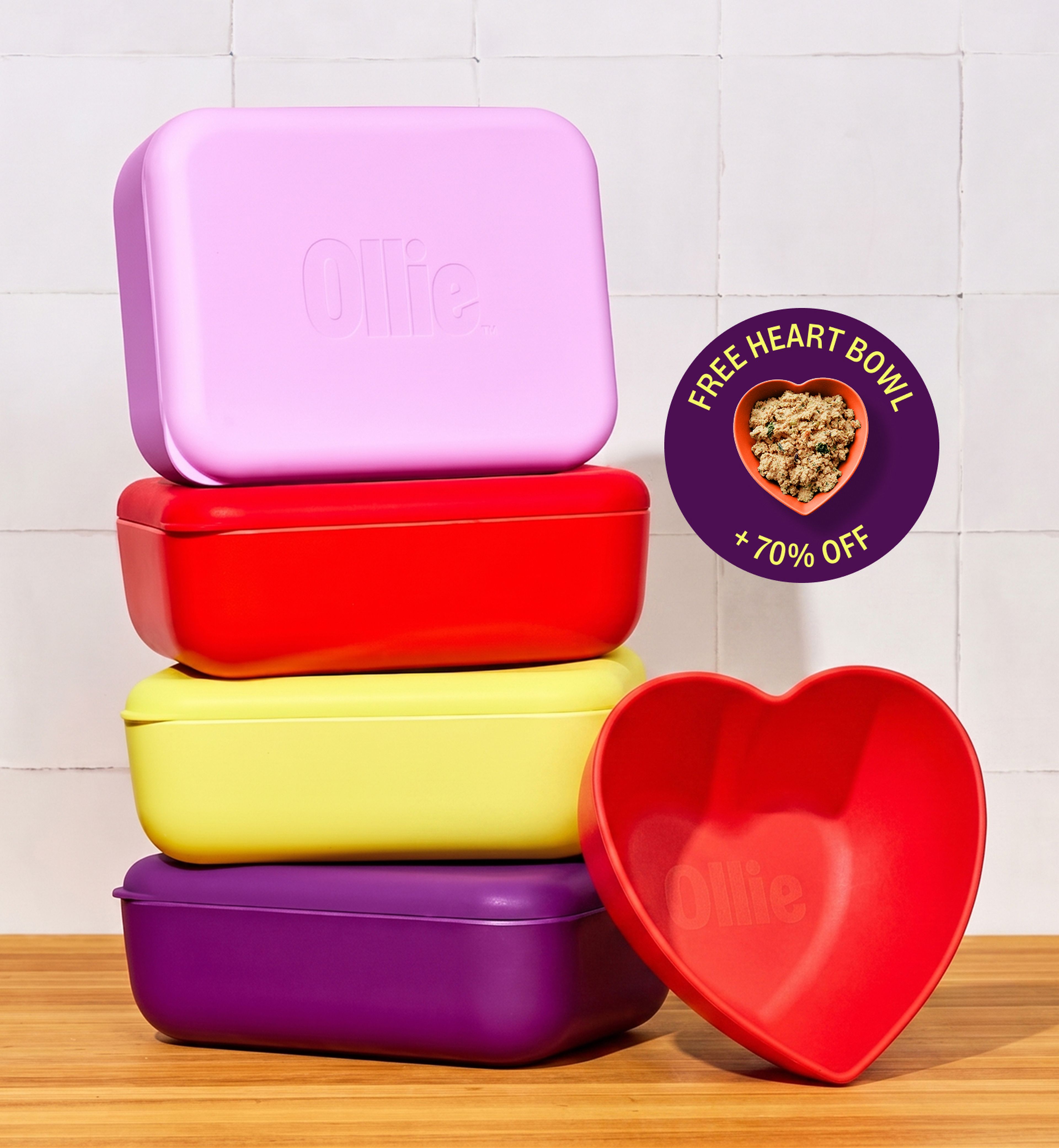Stacked colorful containers and a red heart bowl. Offer sticker shows a heart-shaped bowl filled with food, marked "Free Heart Bowl + 70% OFF."