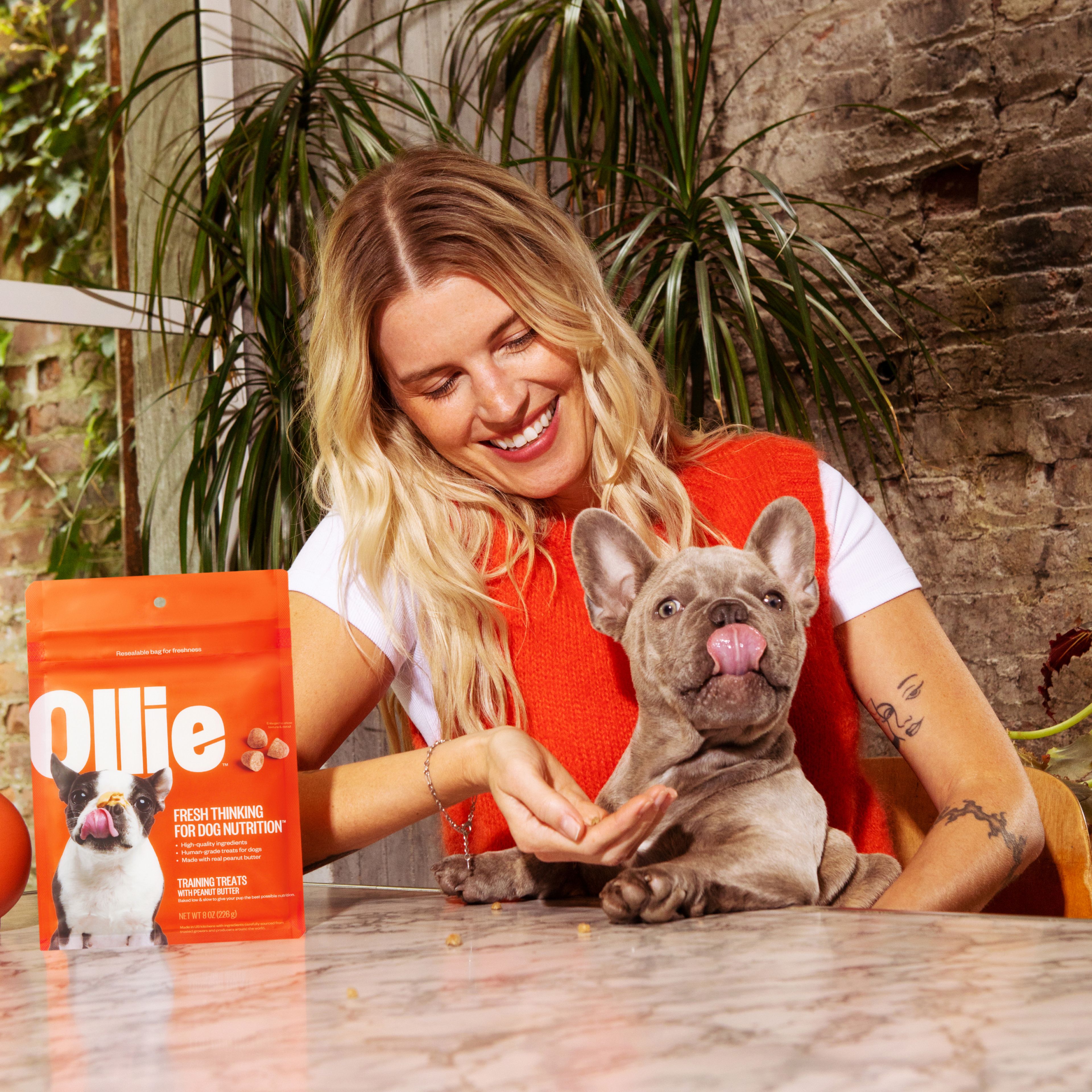 woman feeding dog treats