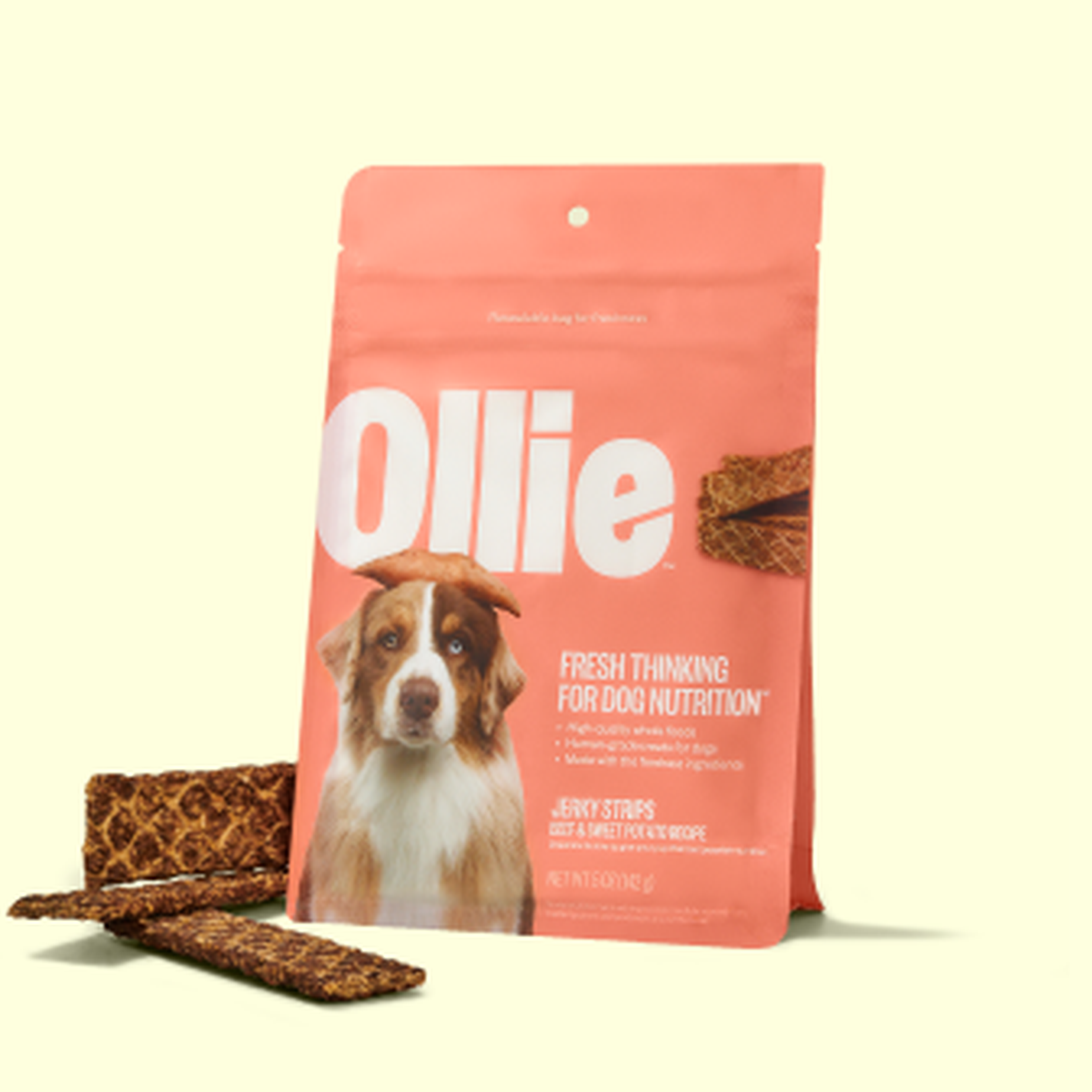 Dog treats packet labeled "Ollie" with jerky strips beside it, featuring a dog image and text promoting fresh dog nutrition.