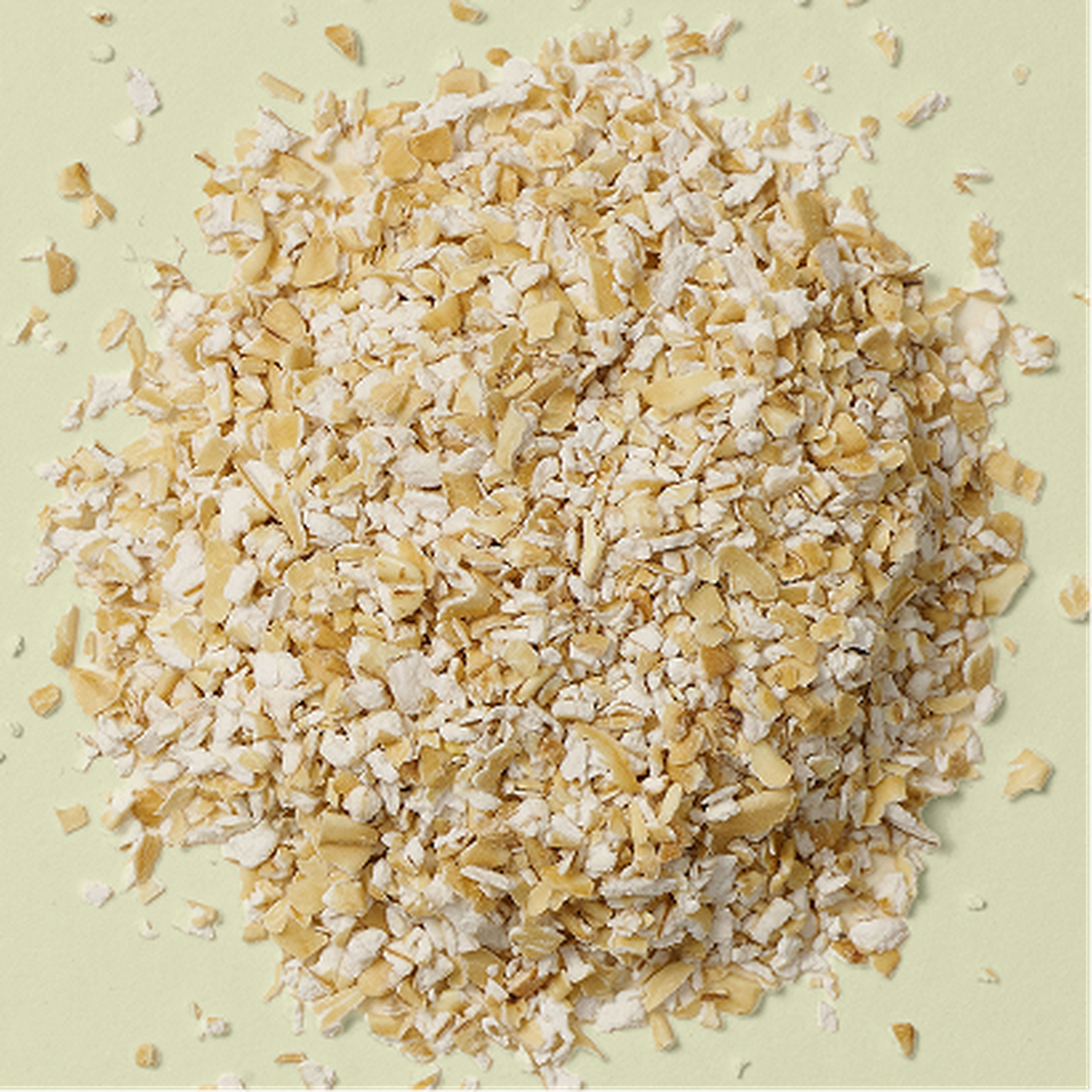 A pile of oats on a light green surface.