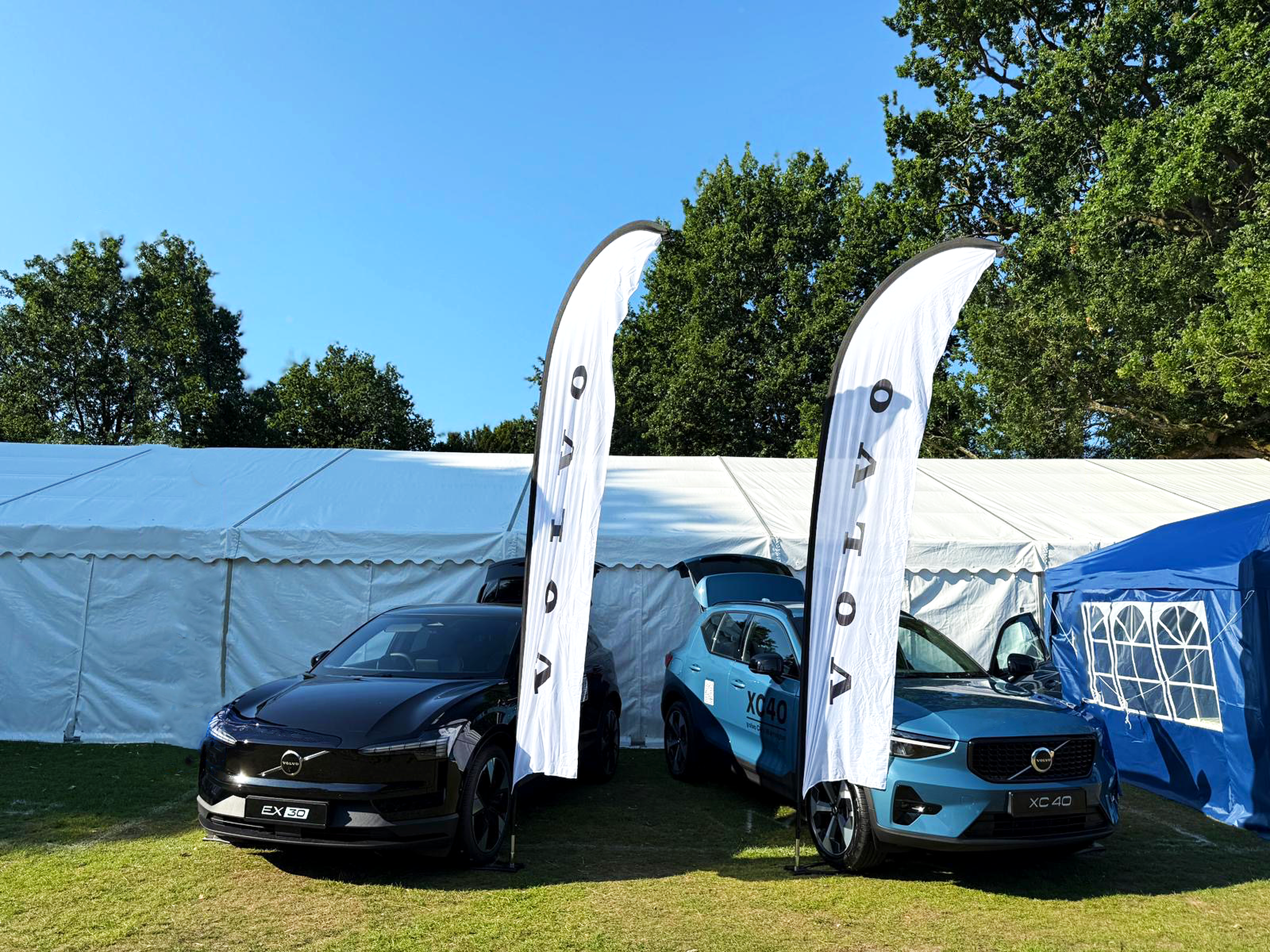 Volvo Cars Warrington Disability Awareness Day 2025 Image 1. Black EX30 and Blue XC40 with Volvo banners