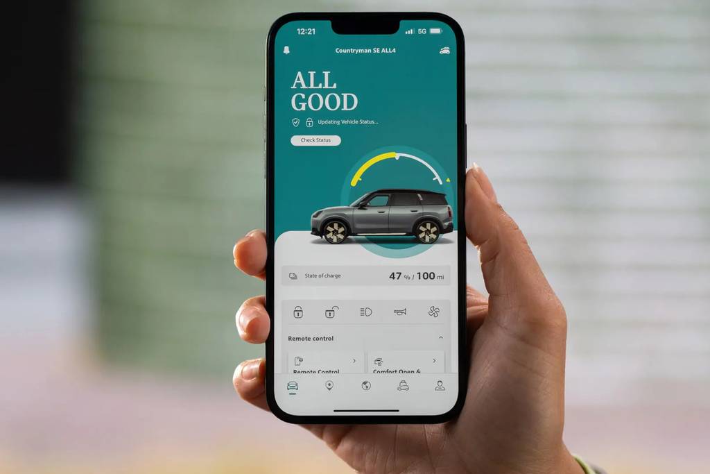 A person holding a smartphone using the MINI app.