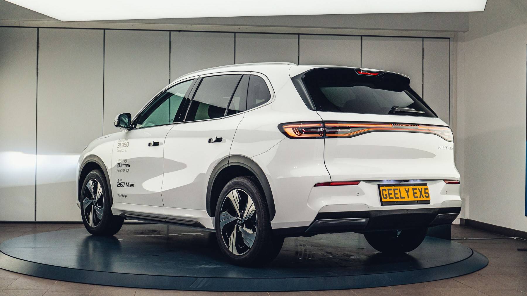 Geely EX5 Exterior - With a white paint finish showcasing the rear three quarters of the vehicle with it sitting on a turntable.
