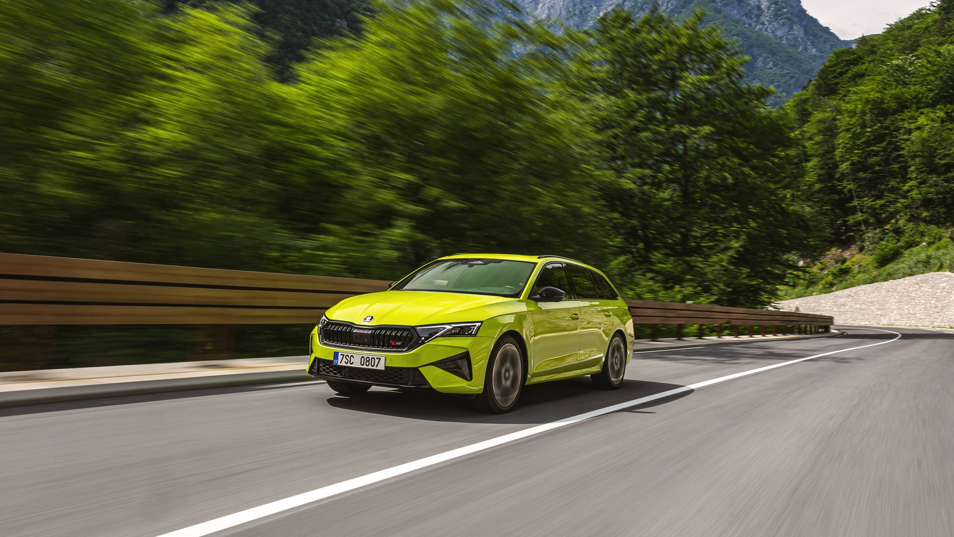 Octavia vRS in neon yellow driving through a mountainous road