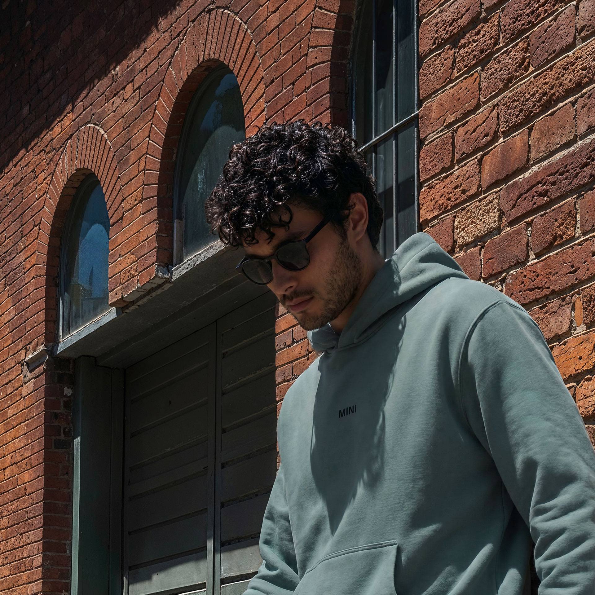 MINI Lifestyle photoshoot with male model showcasing black MINI sunglasses