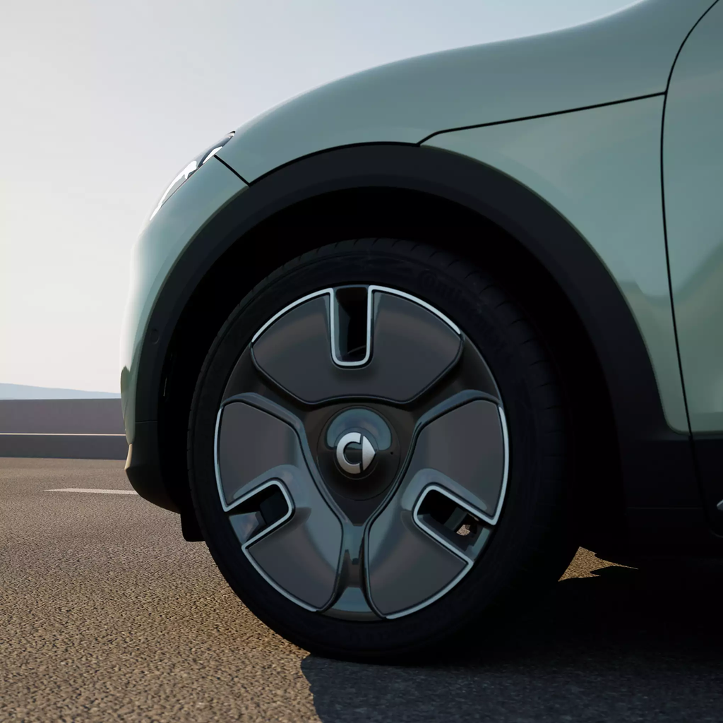 A close up image of the front left wheel of a new smart