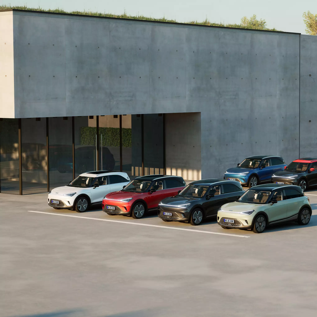 6 cars across the smart range parked outside a building