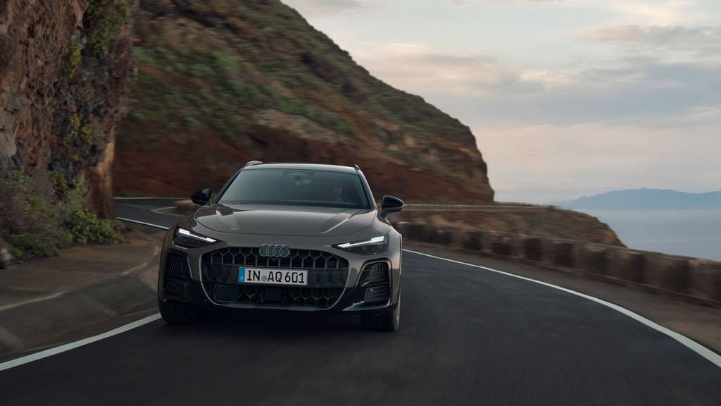 An Audi A6 allroad driving on a bendy road
