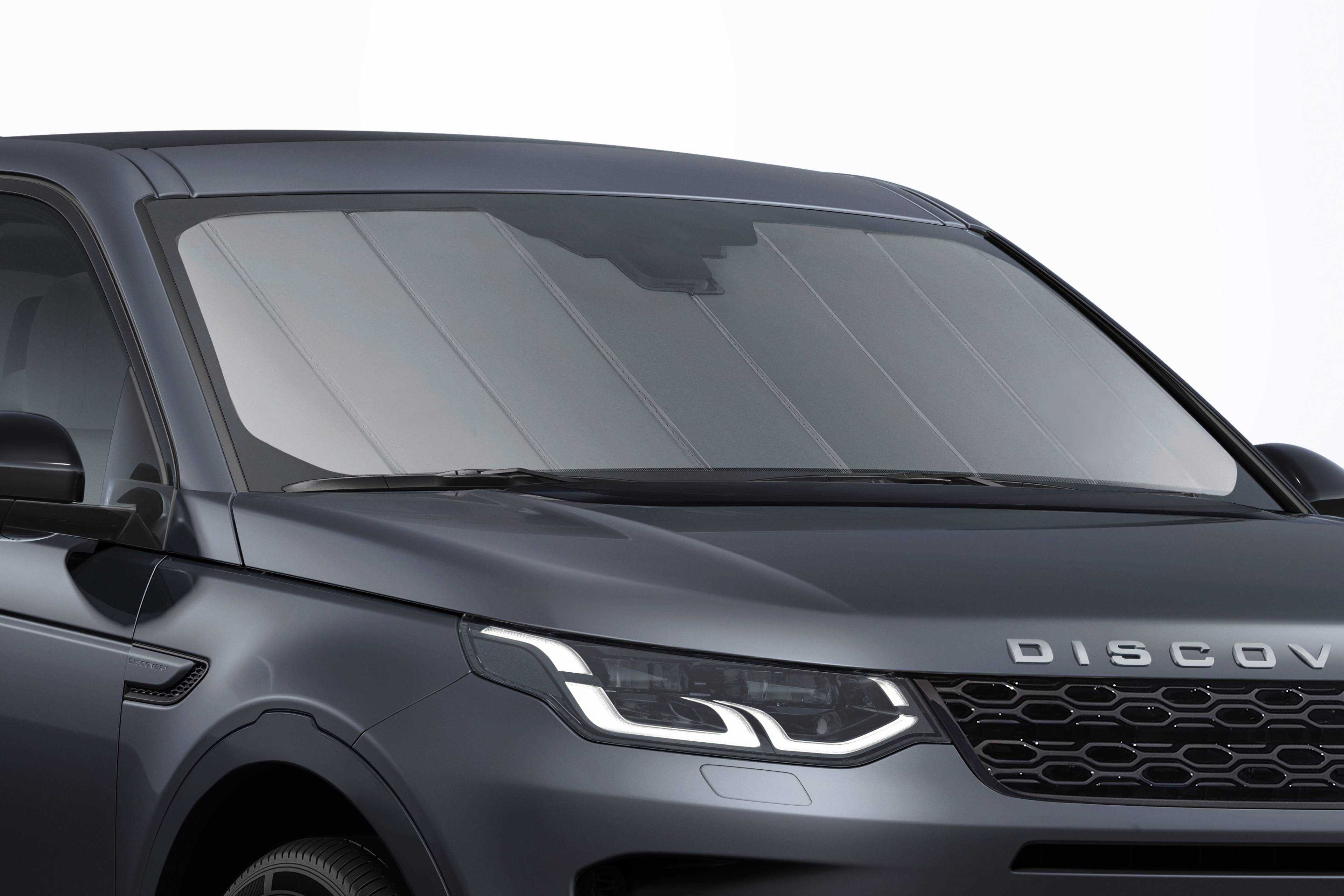 front side view of black discovery sport with a sun shield over the windscreen