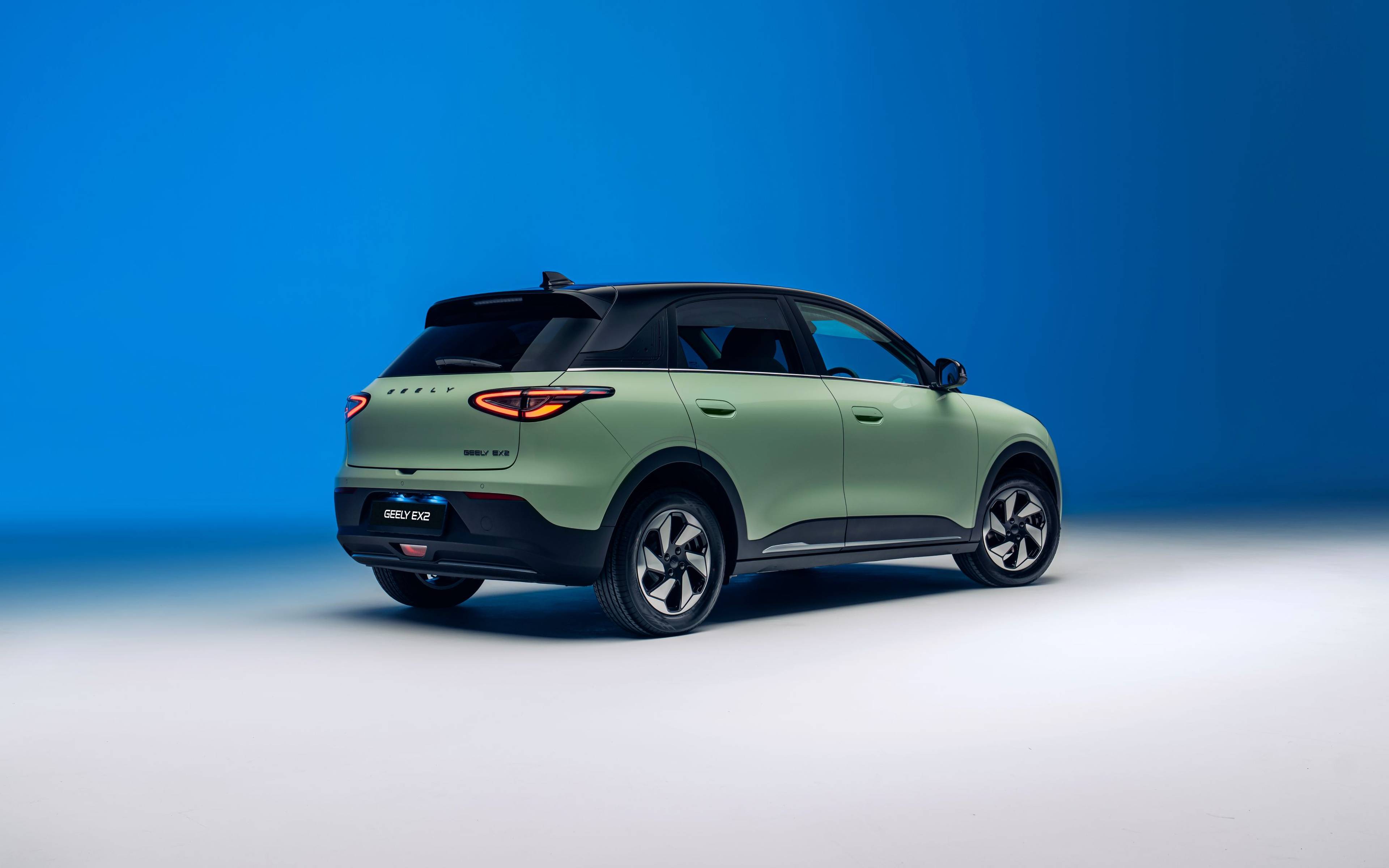 Geely EX2 Rear three quarters in green with a blue gradient background